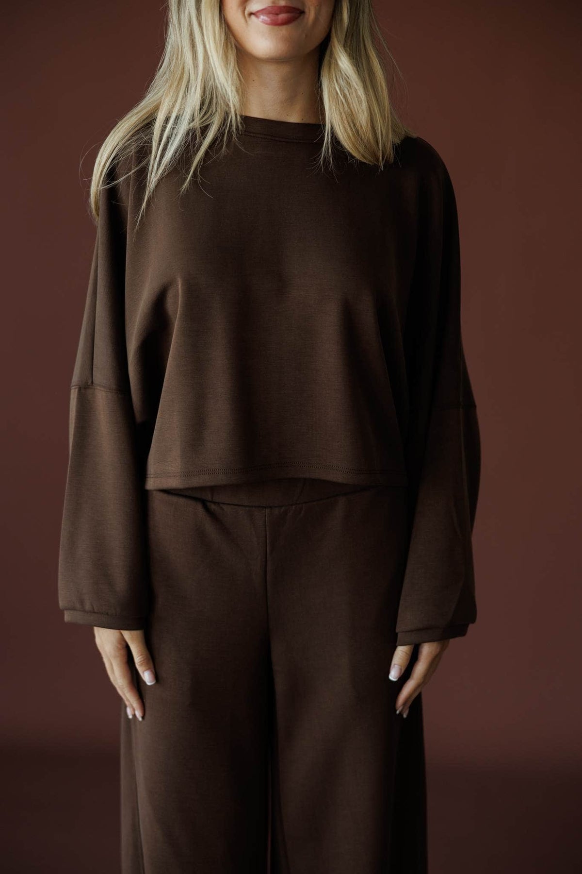 Cropped Scuba Dolman Top in brown, front close-up of the crew neck and dolman sleeves