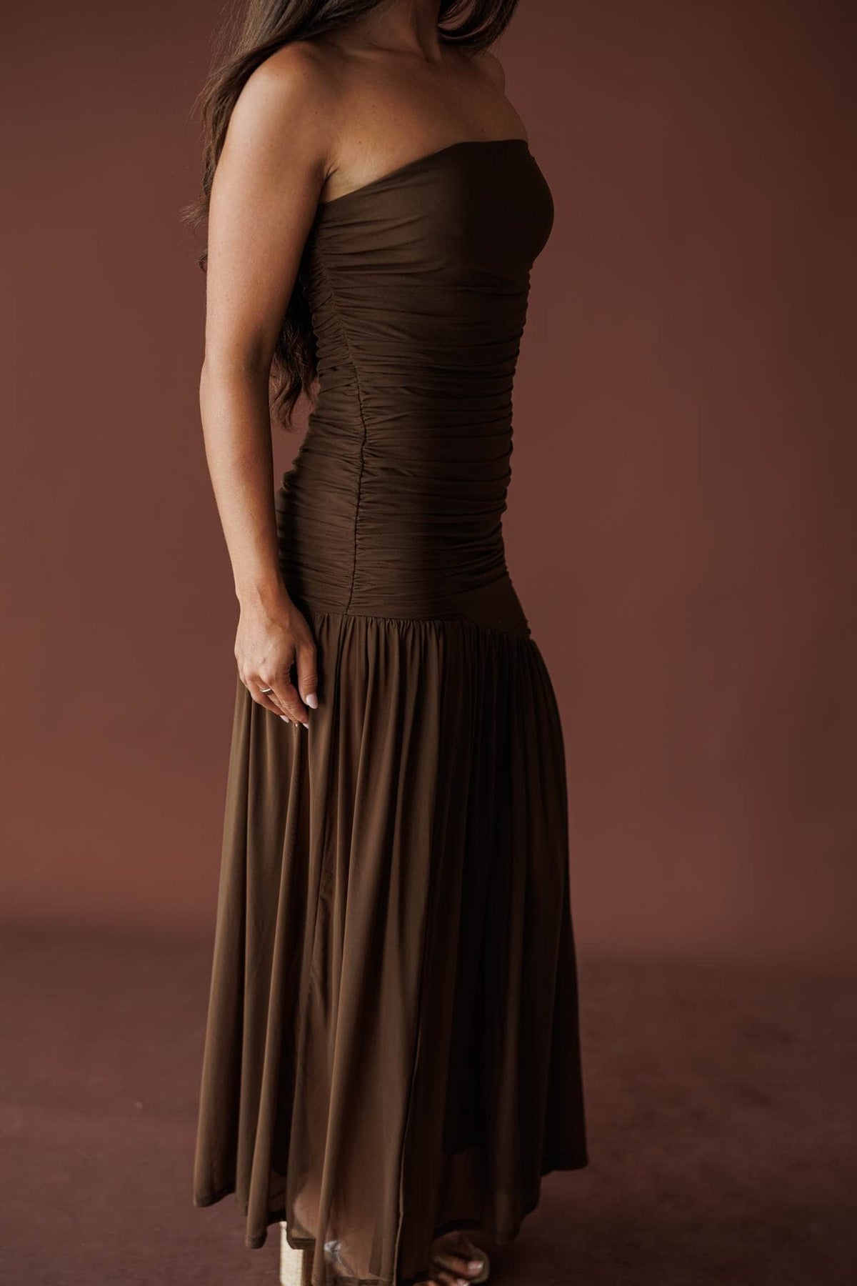 Side view of the mocha ruched bodice and gathered maxi skirt