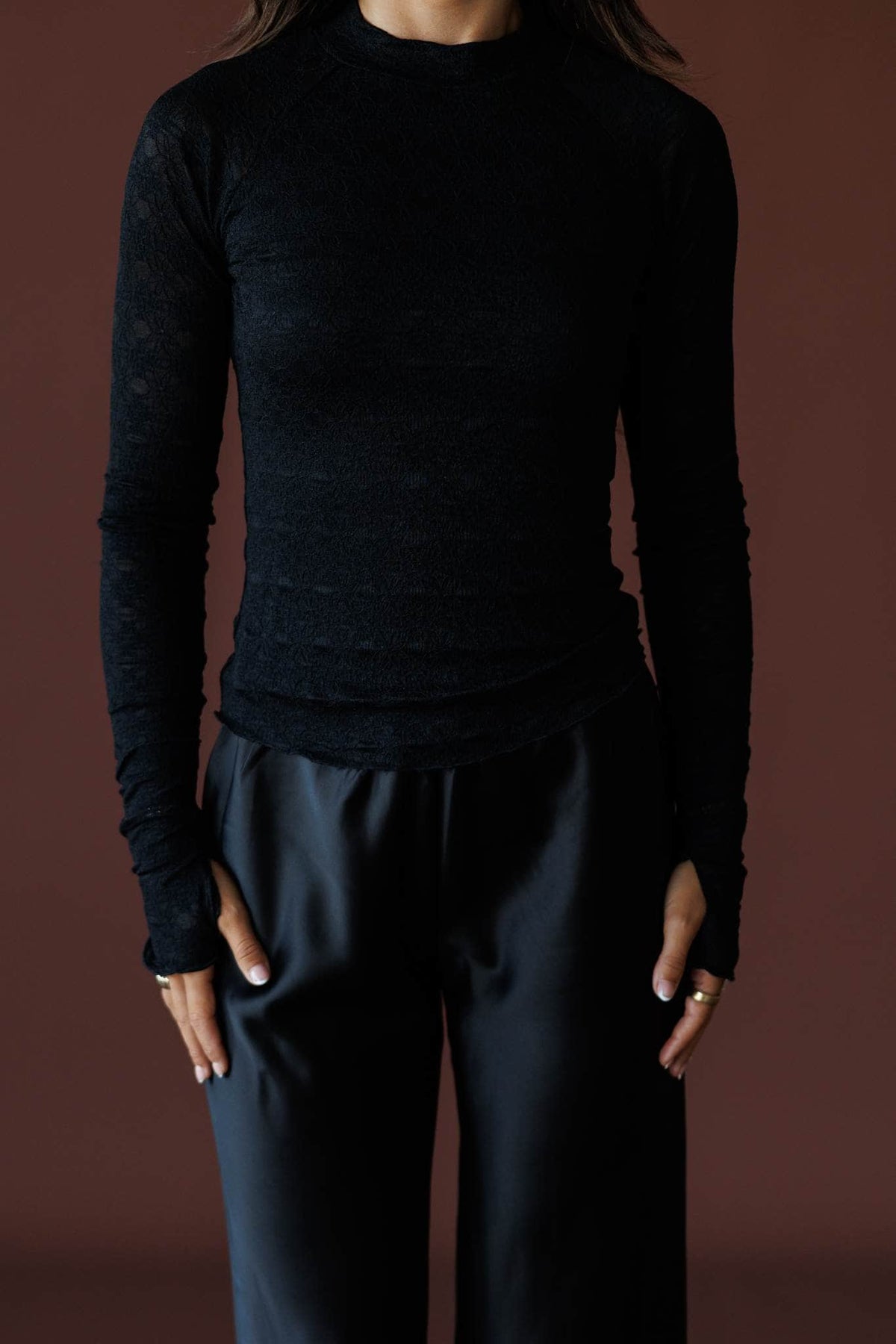Delicate Matter Lace Top in black, front close-up of the mock neck and textured lace