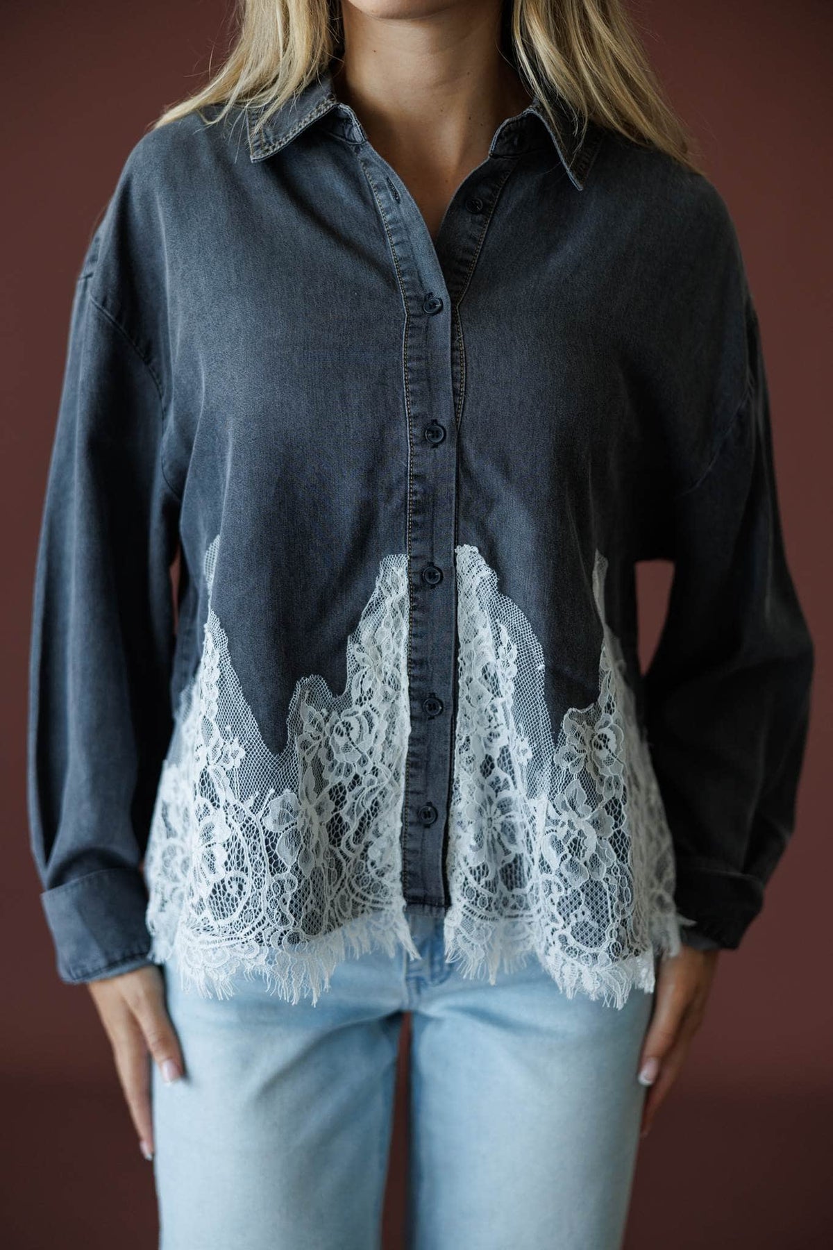 Denim And Delicate Top in black chambray, front close-up of the button front and lace hem