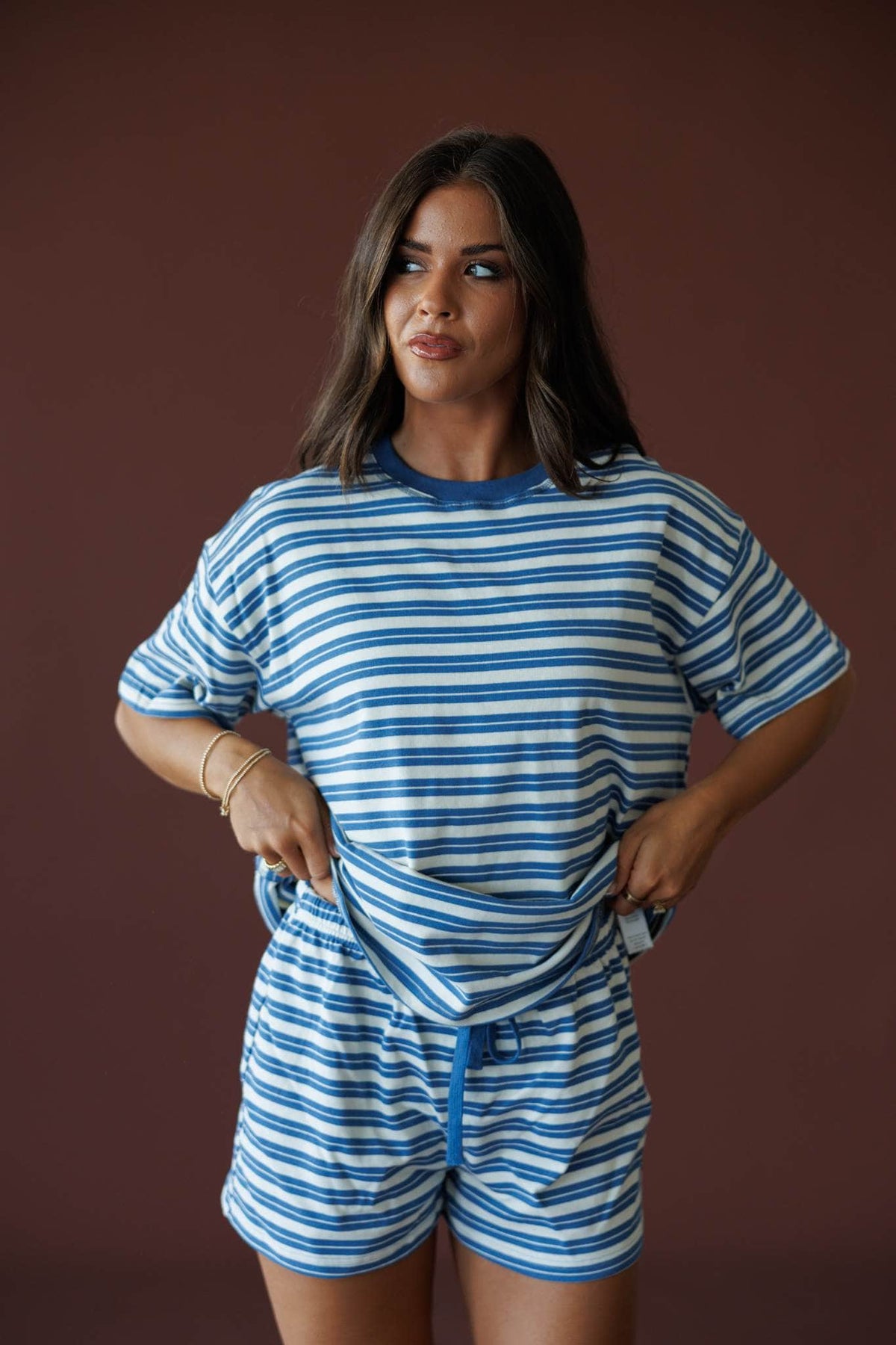 Doing Things Tee in dusty blue, front view on model looking toward the camera