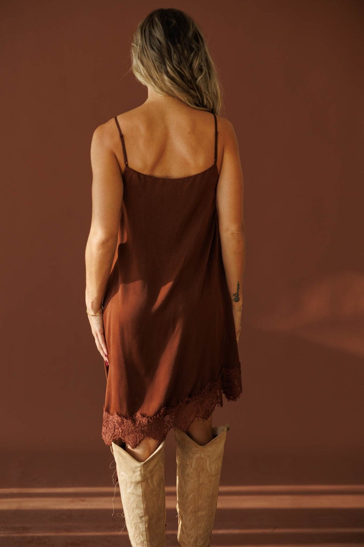 Evening Notes Lace Dress in brown, back view showing the thin straps and lace hem