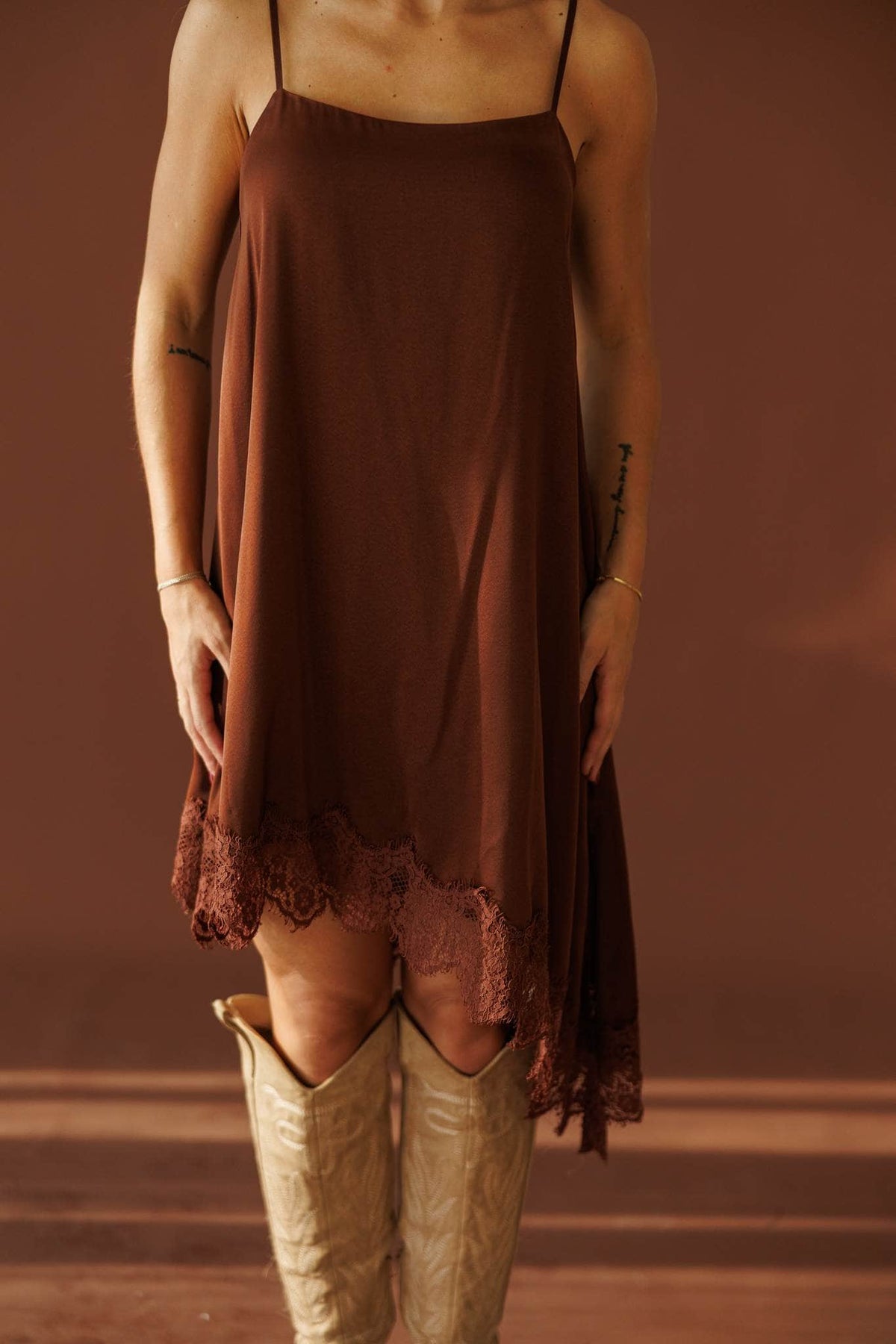 Evening Notes Lace Dress in brown, front close-up of the lace trim hem