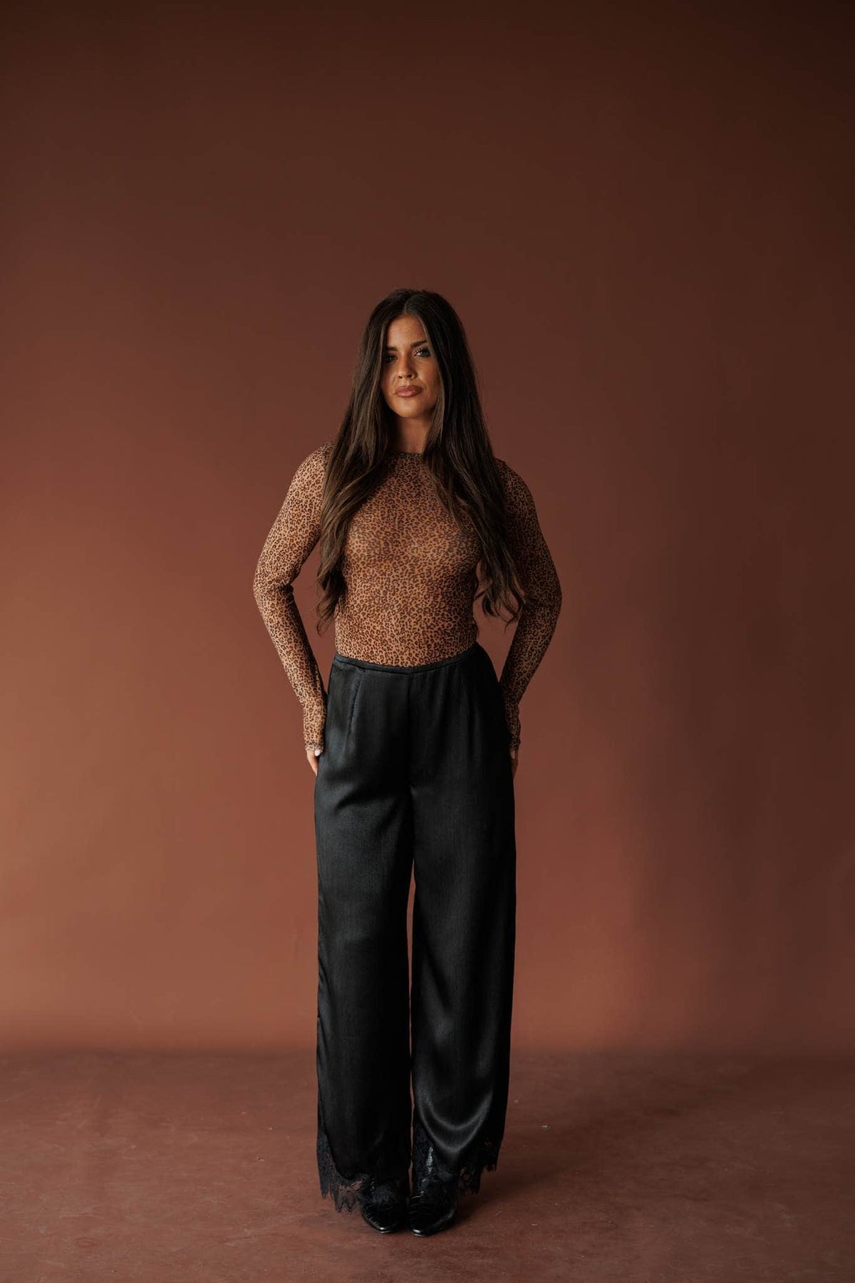 Burnt Sugar Mesh Top, in tawny brown, full-length front view with black trousers