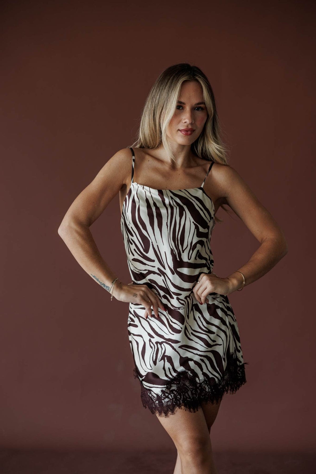 Serengeti Satin Slip Mini, in brown and ecru, three-quarter front view with hands on hips