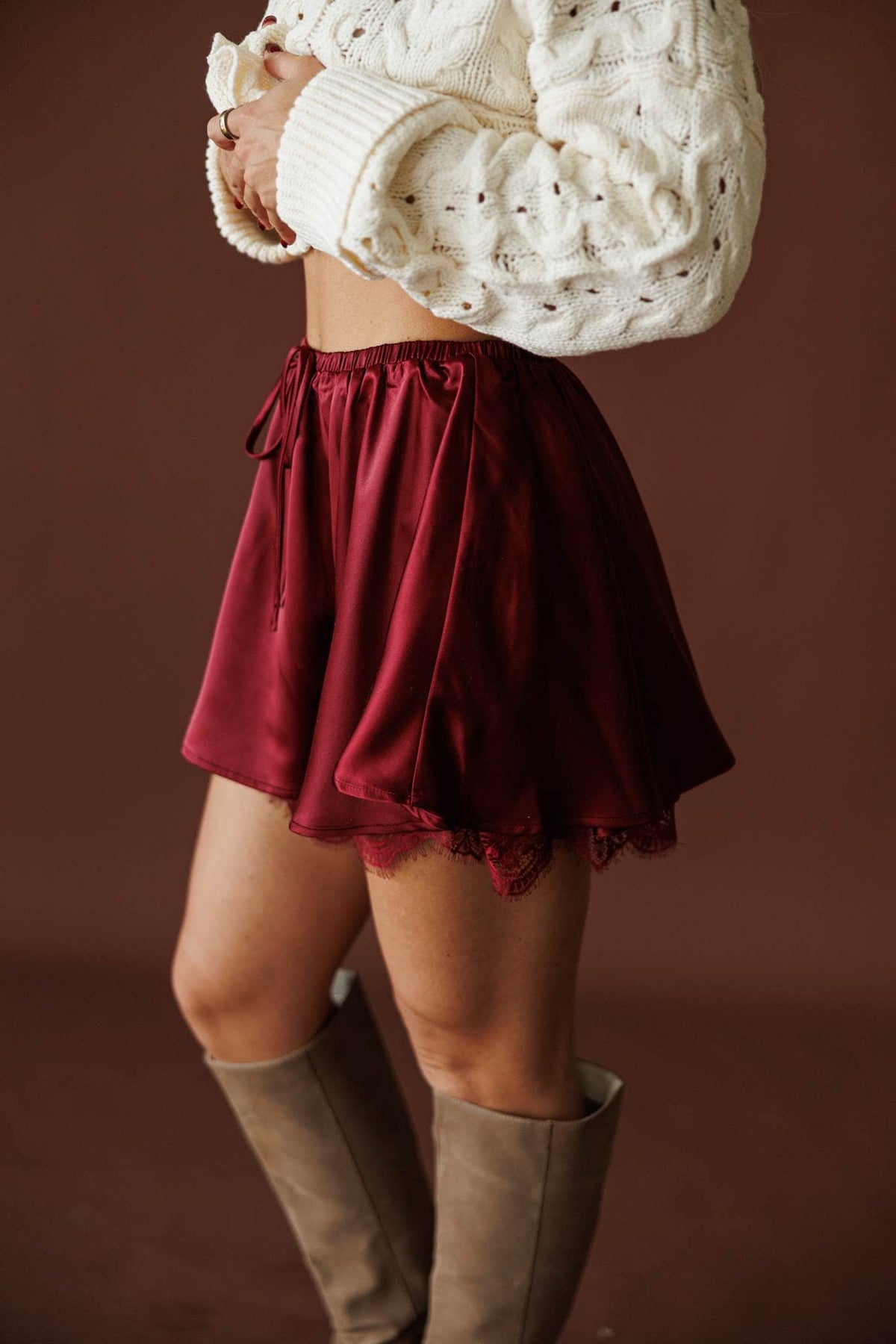 Satin And Lace Skort in burgundy, side view of the lace hem and drawcord waist