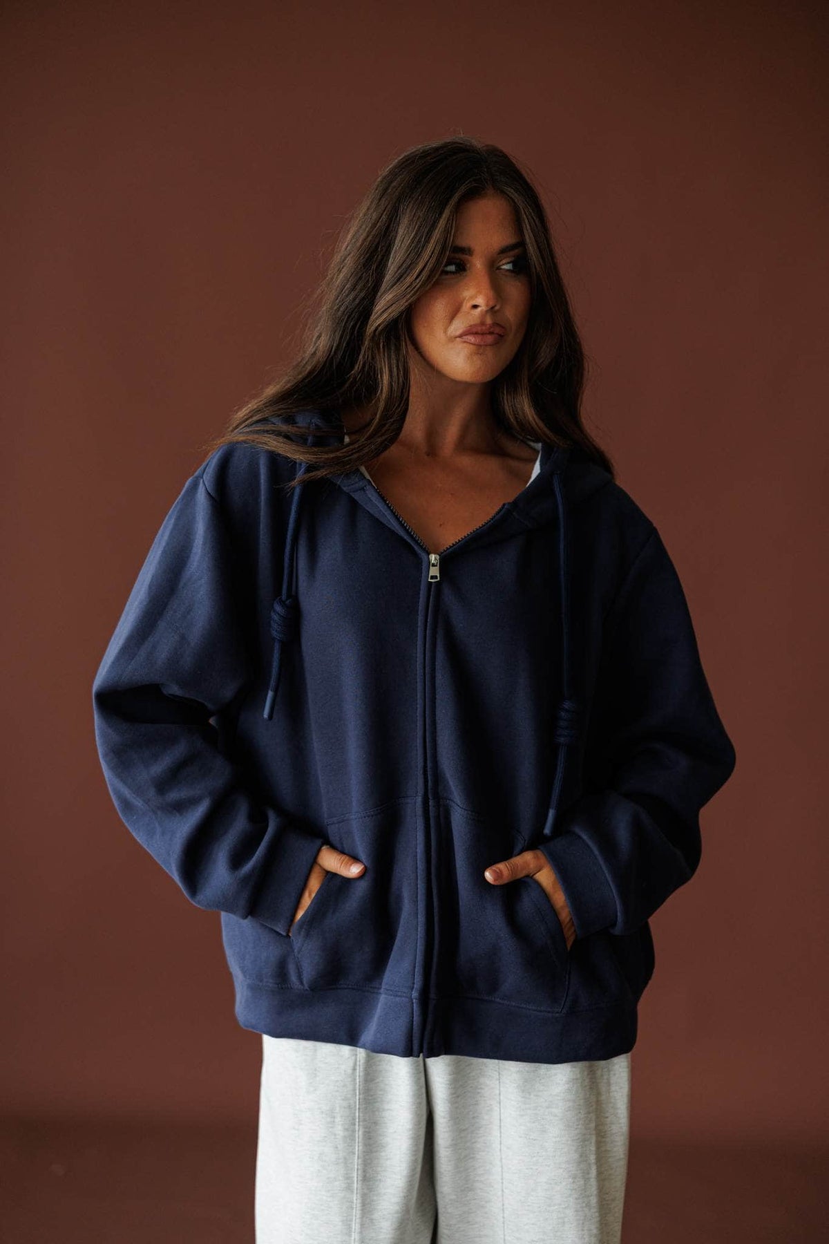 On Standby Zip Up Jacket in navy, front view worn open with hands in the pockets
