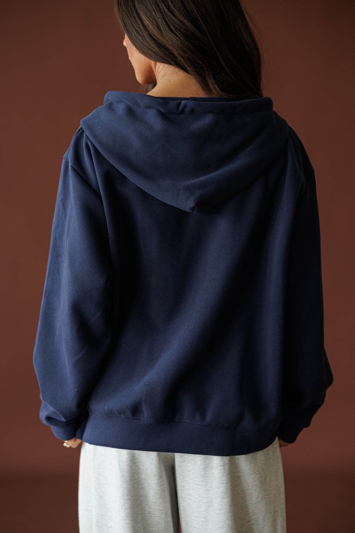 On Standby Zip Up Jacket in navy, back view showing the hood
