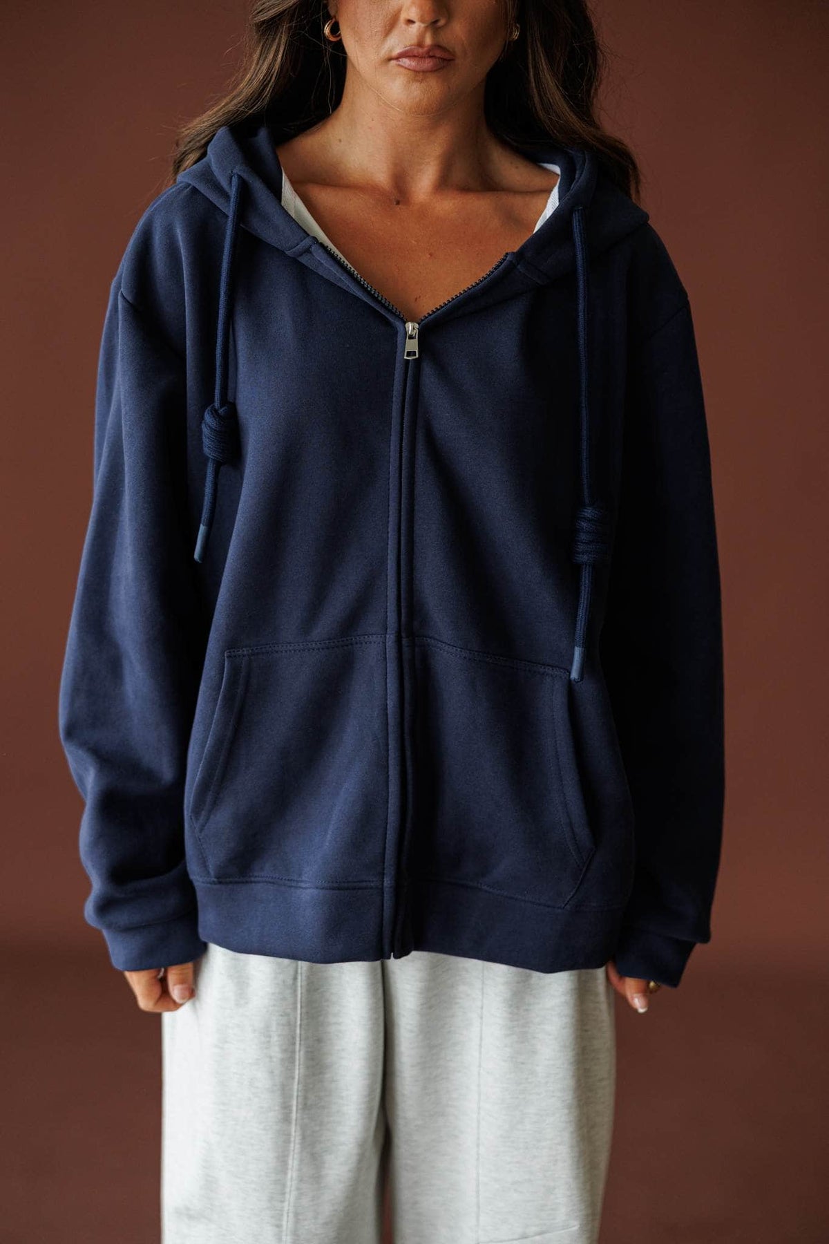 On Standby Zip Up Jacket in navy, front view of the full zip and hood