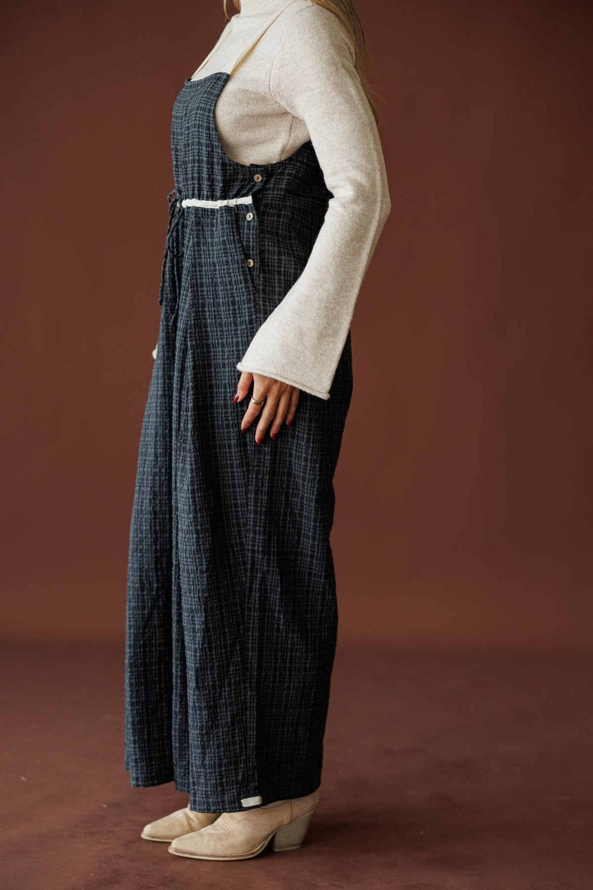 Field Trip Overalls in black plaid, side view showing the roomy leg
