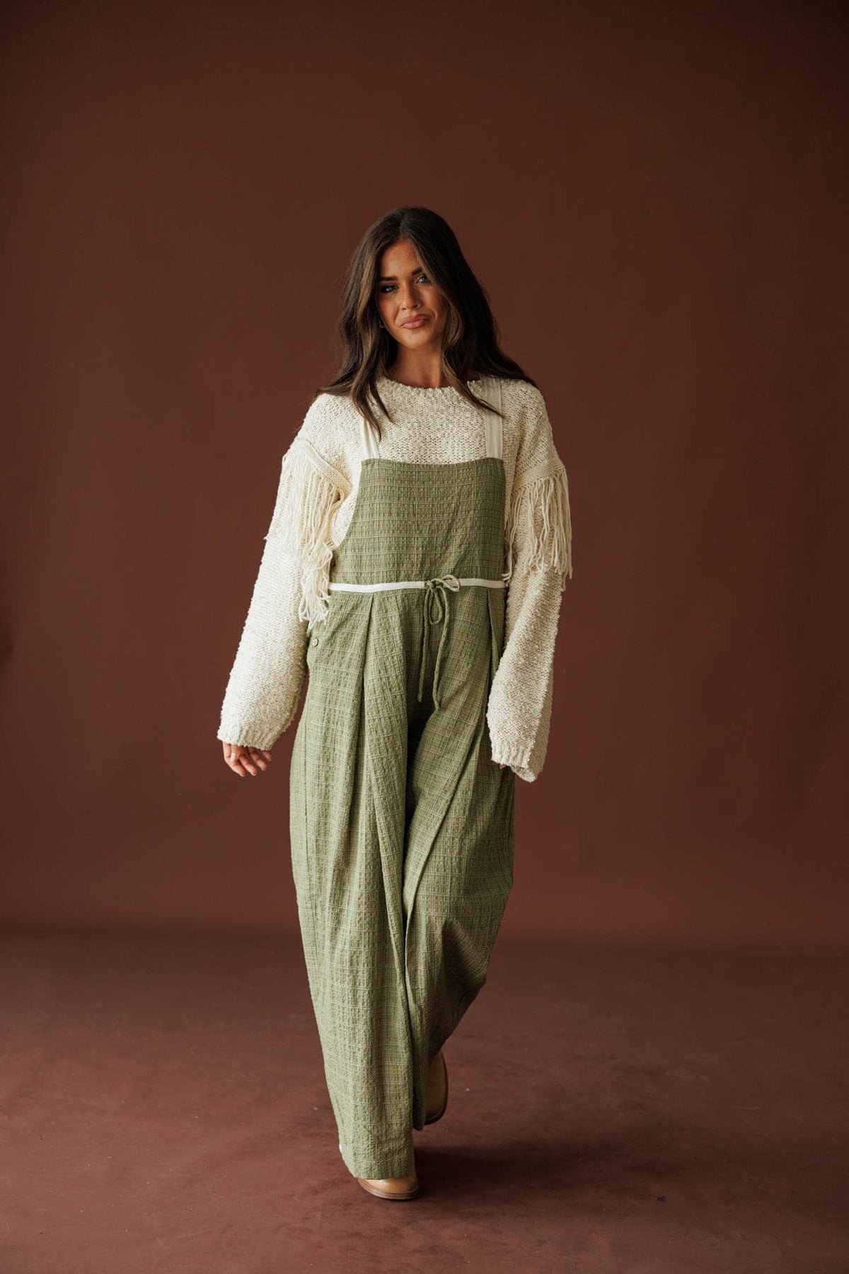 Field Trip Overalls in olive, full-length front view with a cream sweater