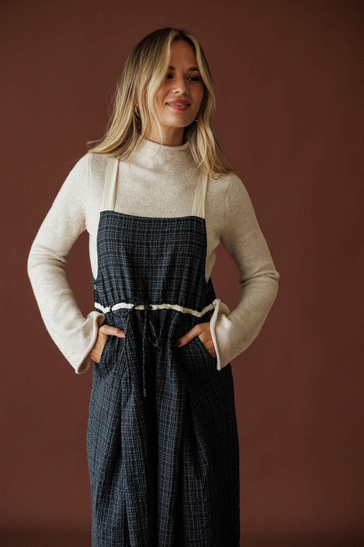 Field Trip Overalls in black plaid, front view of the drawcord waist and straps