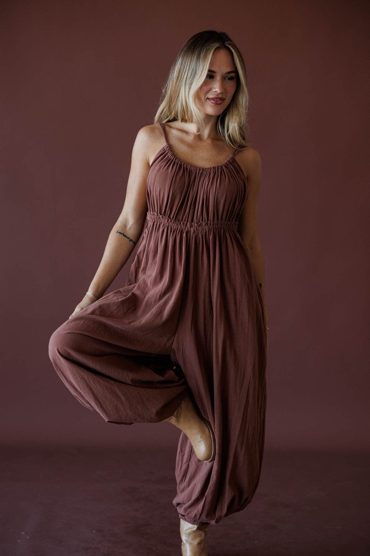 The Roam Jumpsuit, in brown, three-quarter front view of the jumpsuit