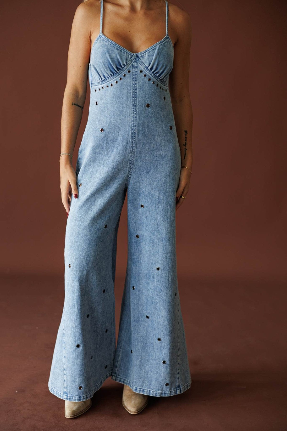 Motel Rodeo Denim Jumpsuit in light denim, front view of the sweetheart bodice and wide leg