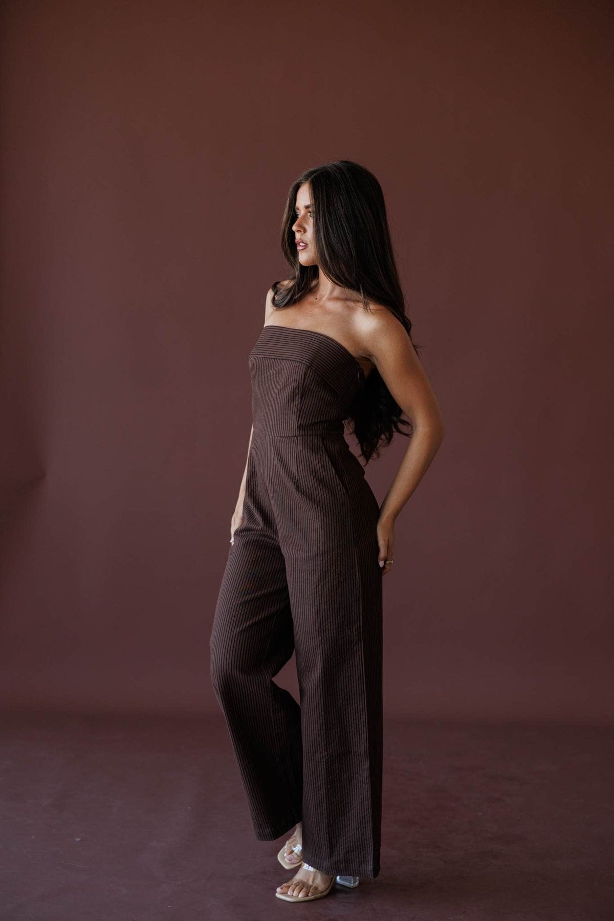 Cocoa Hour Strapless Jumpsuit, in brown, side view of the tapered leg