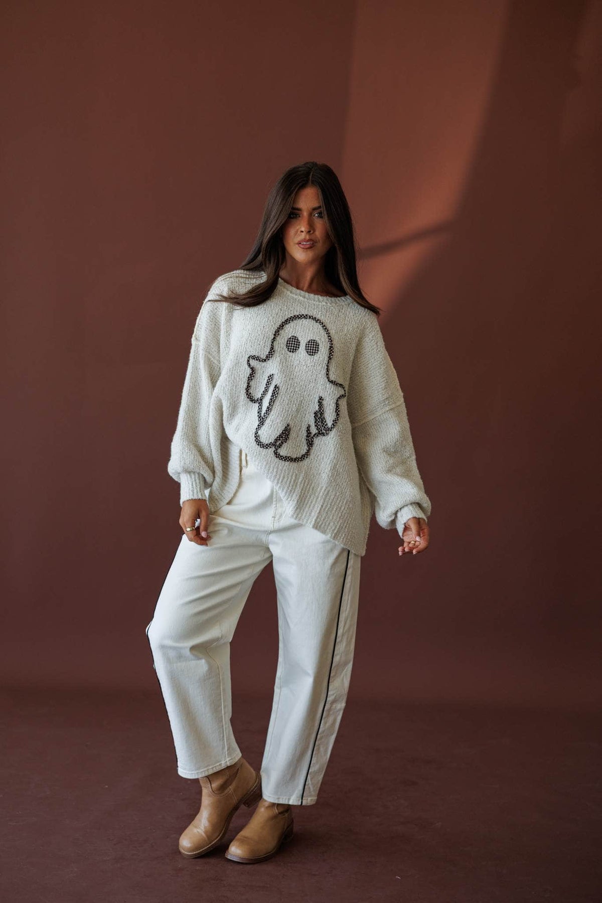 Friendly Ghost Sweater, full-length front view with cream pants