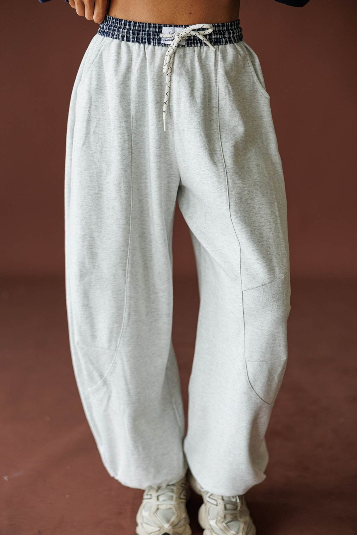 Slow Down Wide Leg Joggers in light heather grey, front view of the drawcord waist with sneakers