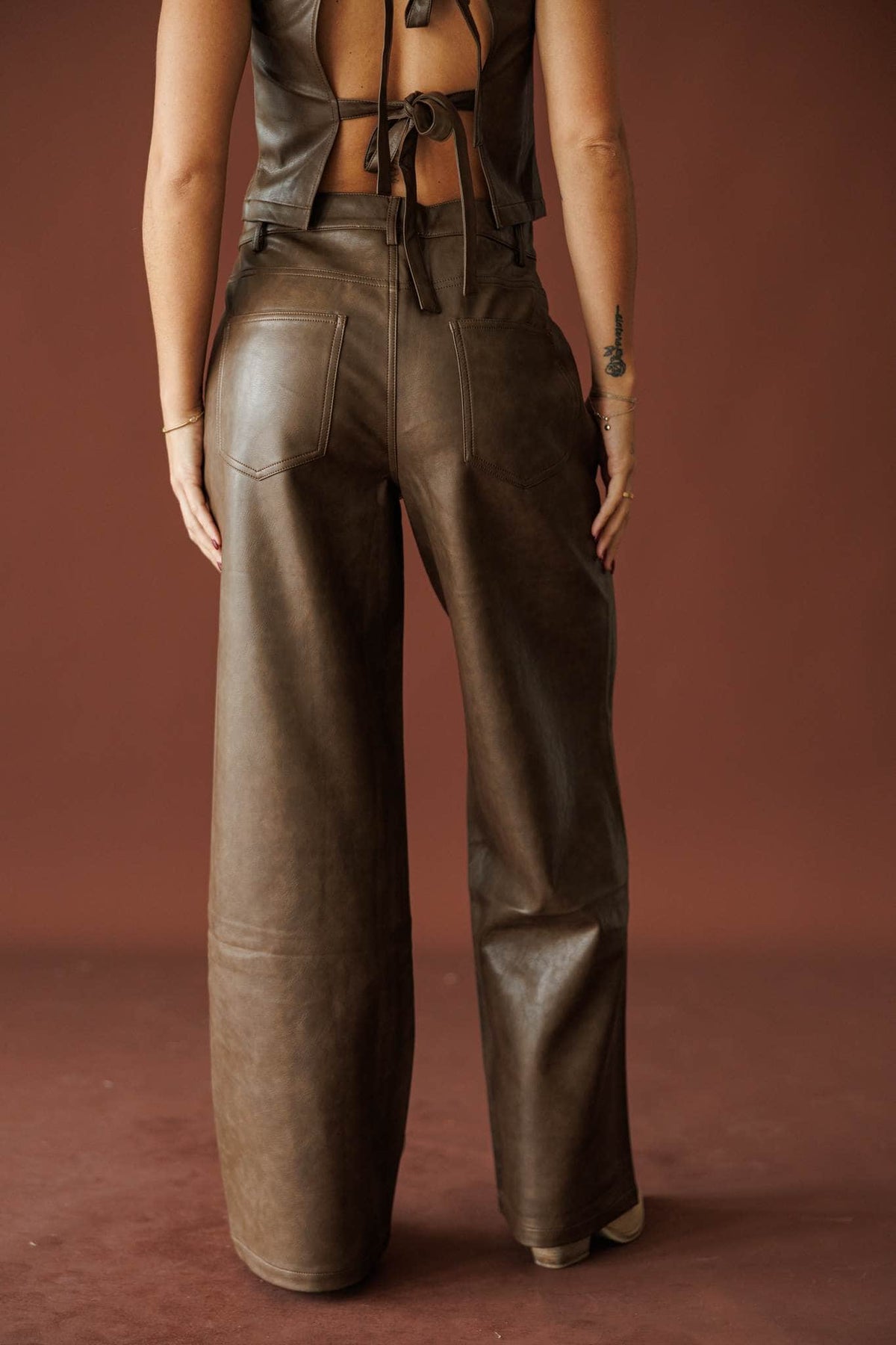 Trouble Tonight Leather Pants in brown, back view of the high waist and wide leg