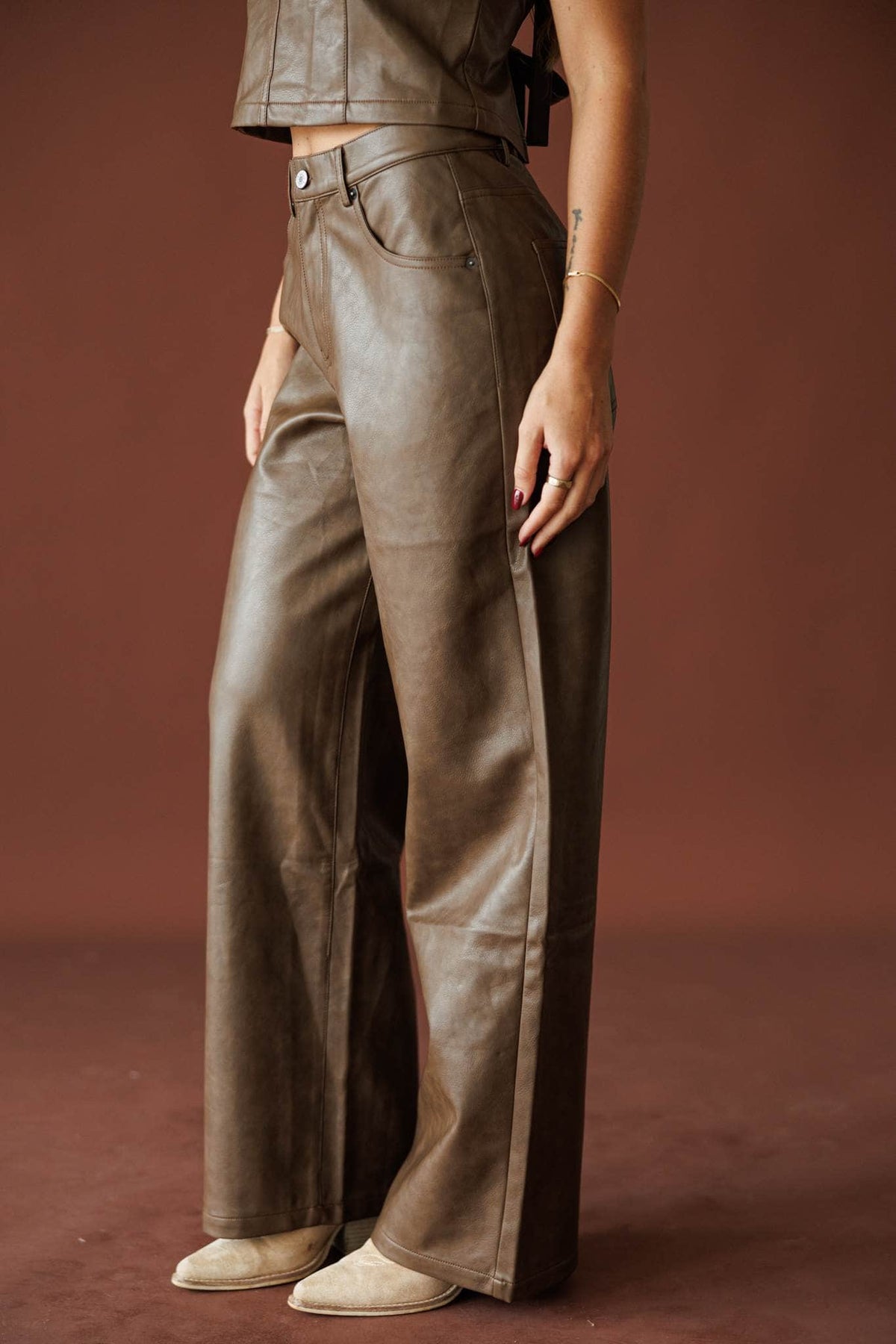 Trouble Tonight Leather Pants in brown, side view of the faux leather panelling