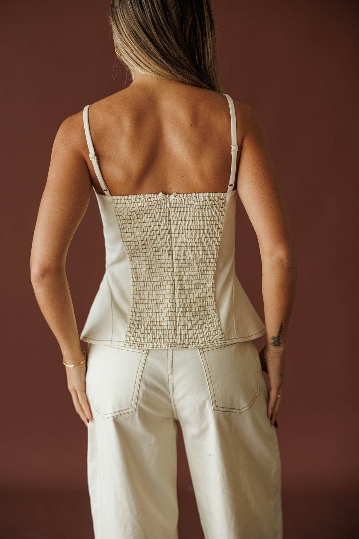 Roadhouse Peplum Top in cream, back view of the smocked back panel