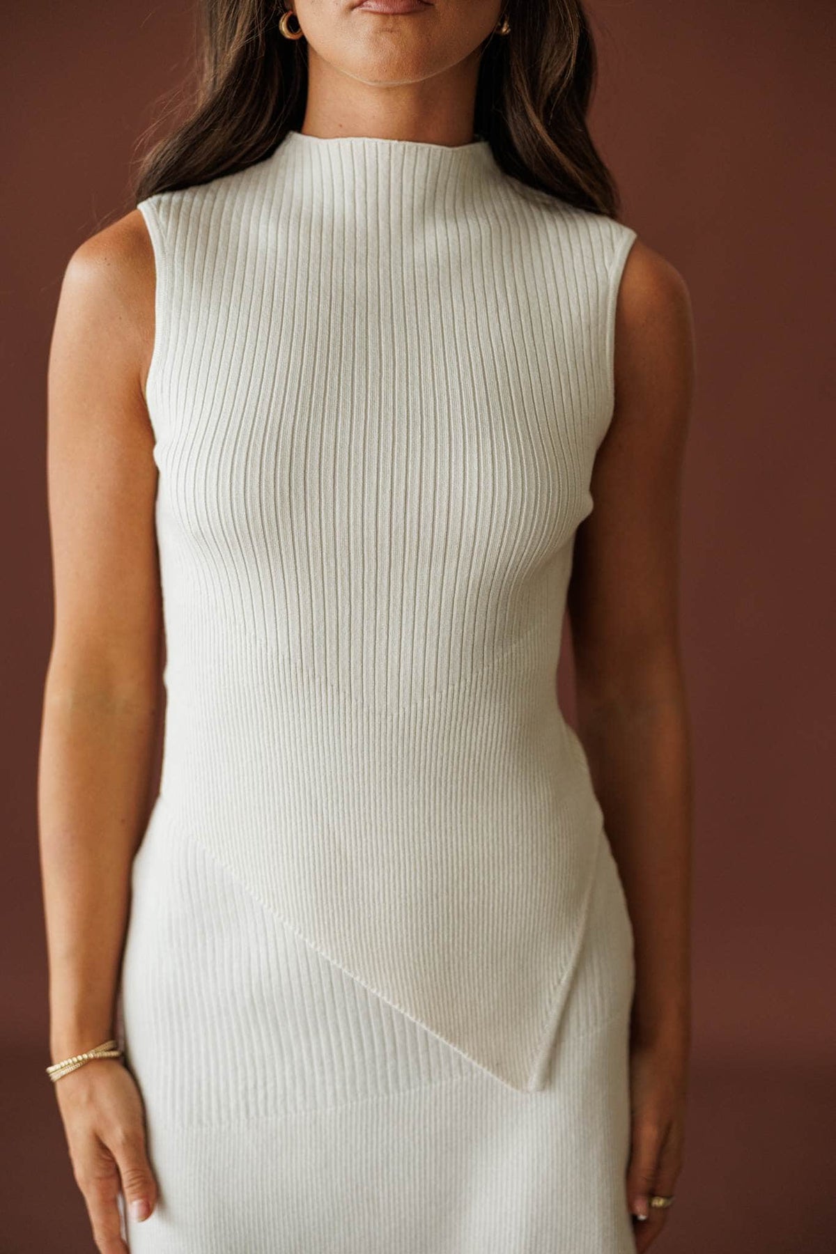 West Village Top in cream, front view of the mock neckline and asymmetric hem