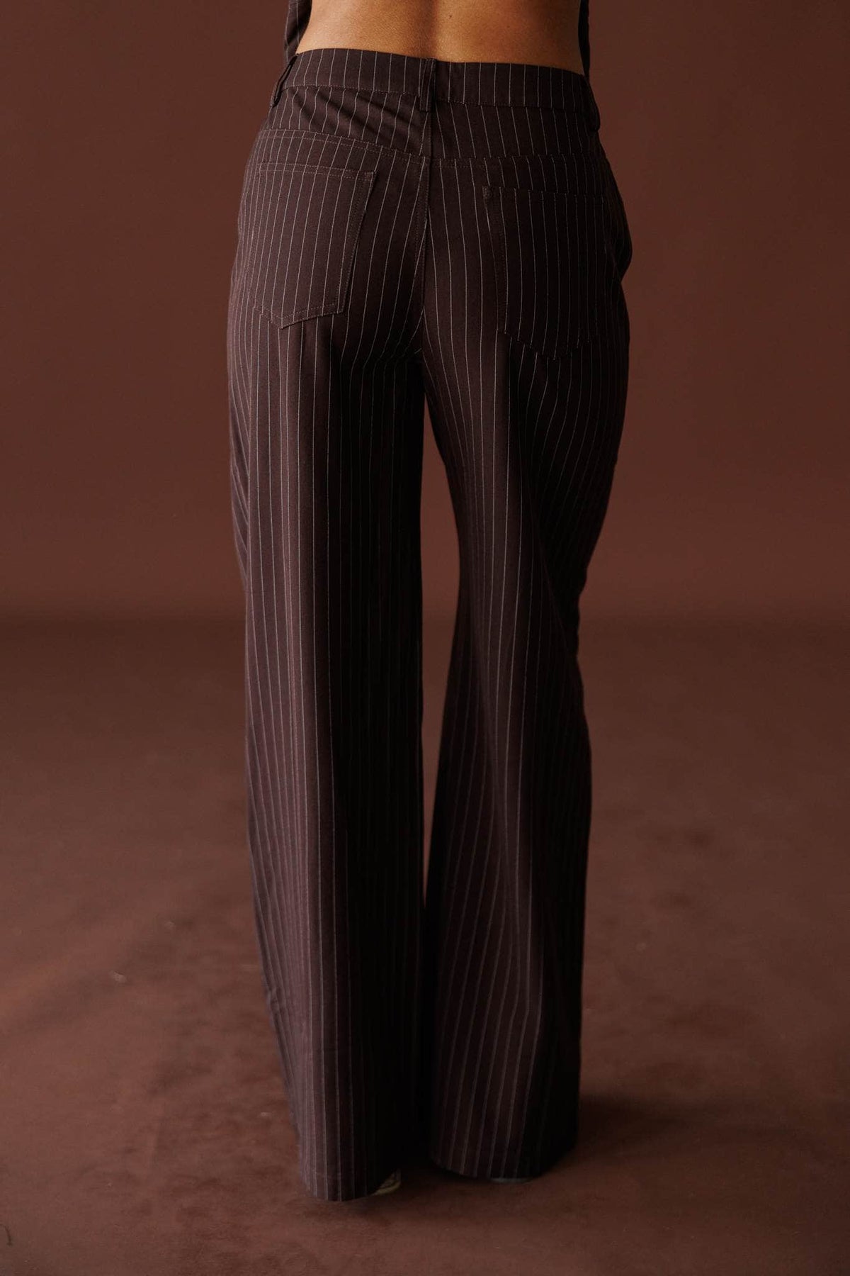 Members Only Pants in brown pinstripe, back view of the wide-leg silhouette