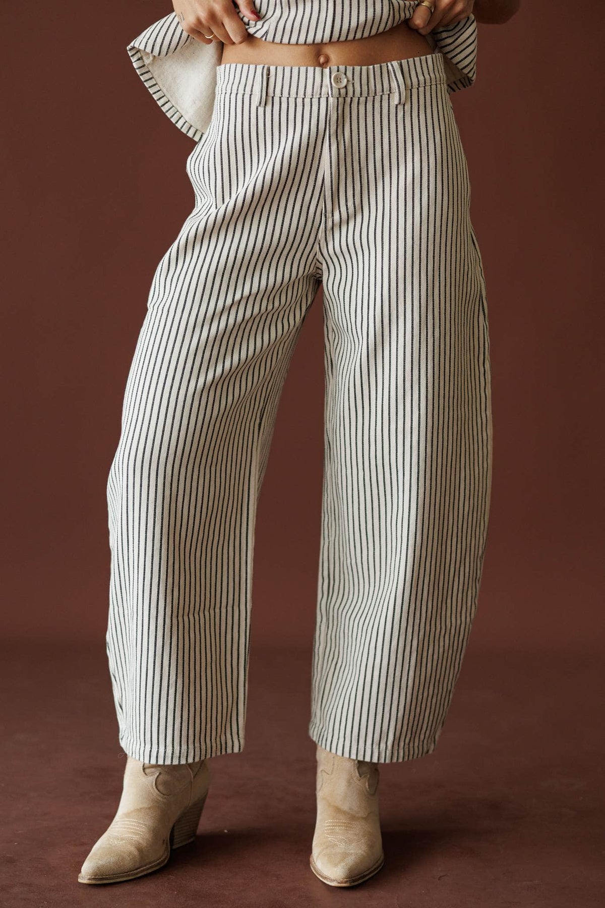 Day In The City Barrel Pants in natural pinstripe, front view of the barrel leg with booties