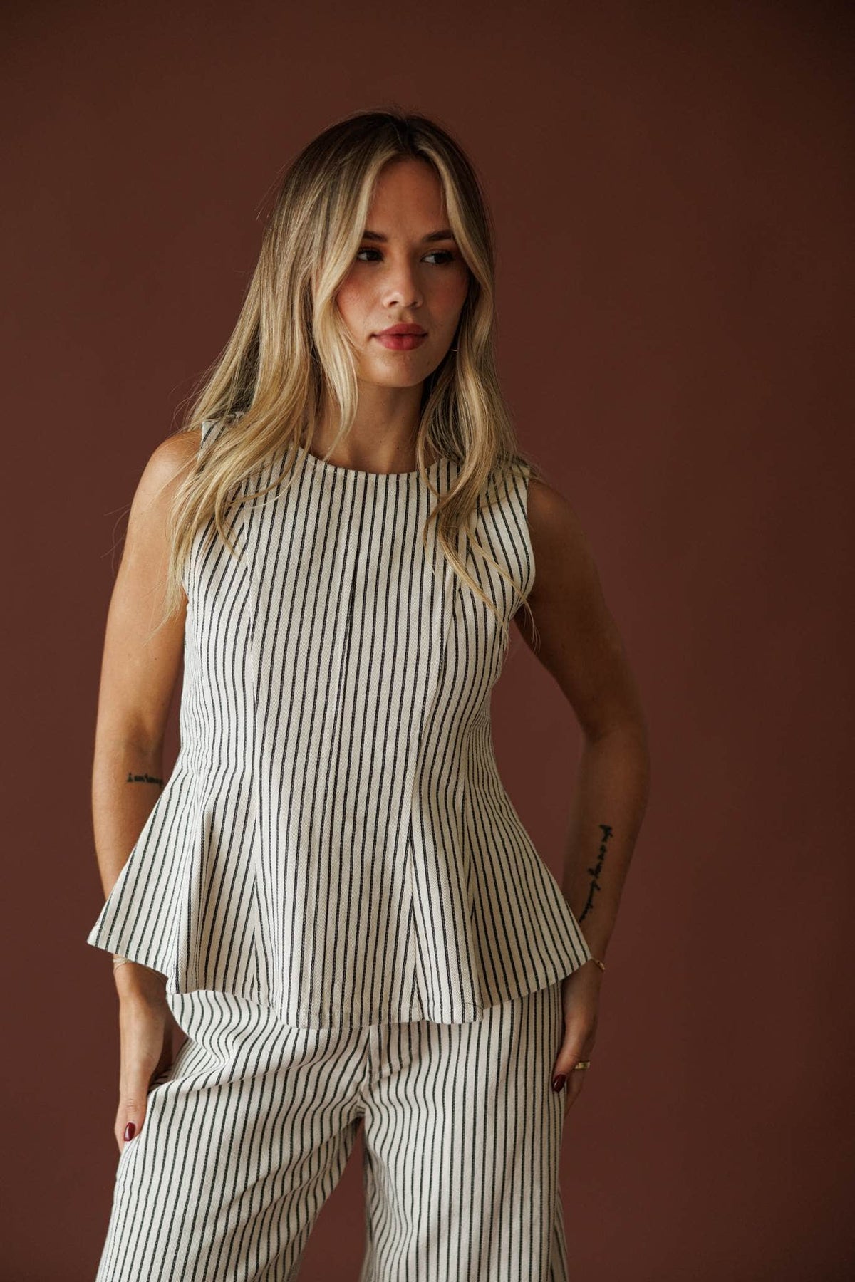 Day In The City Top in natural pinstripe, three-quarter front view with hand on hip