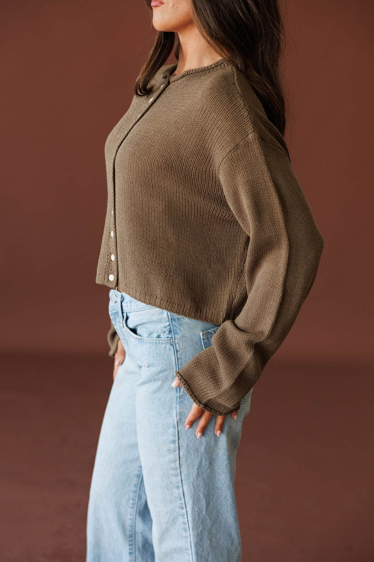 Common Ground Cardigan in olive, side view showing the balloon knit sleeve
