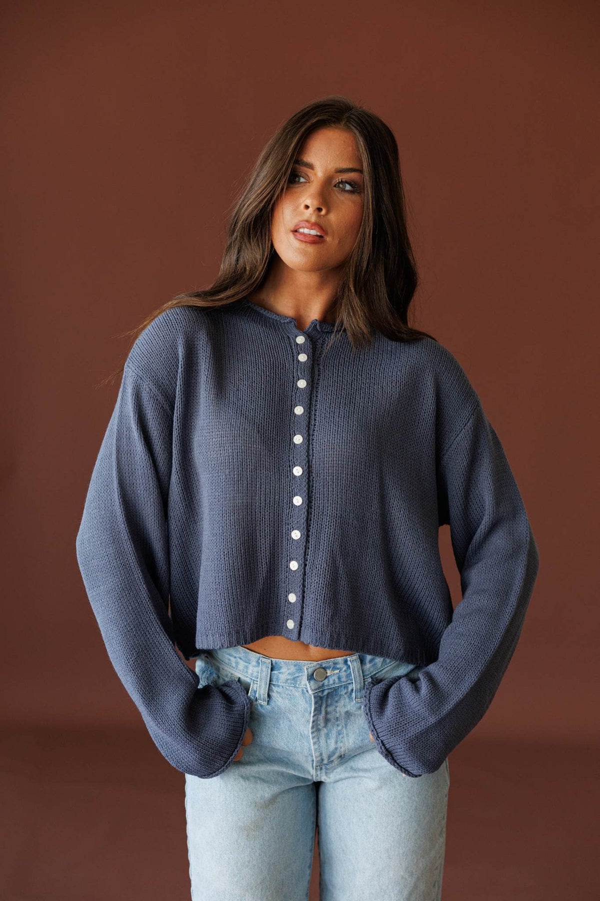 Common Ground Cardigan in nightfall, full-length view with light wash jeans