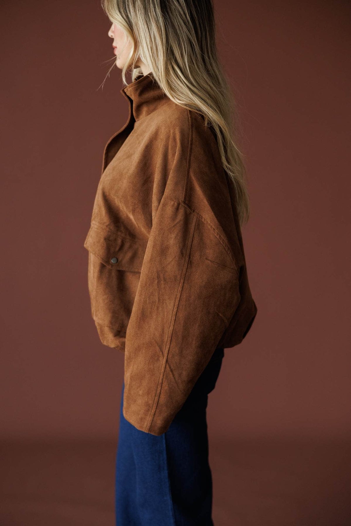 The Outsider Jacket in brown, side view showing the slouchy suede sleeve