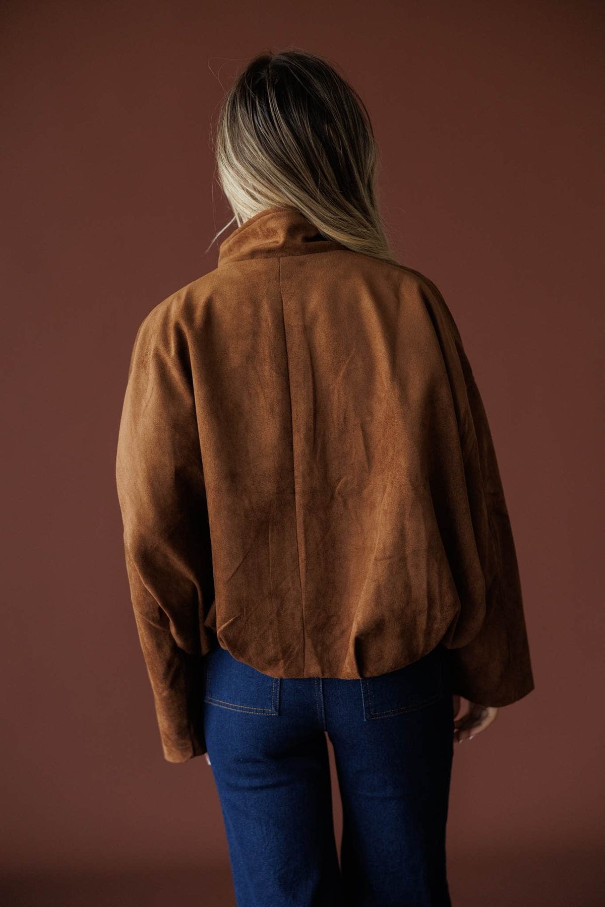 The Outsider Jacket in brown, back view showing the boxy suede bomber