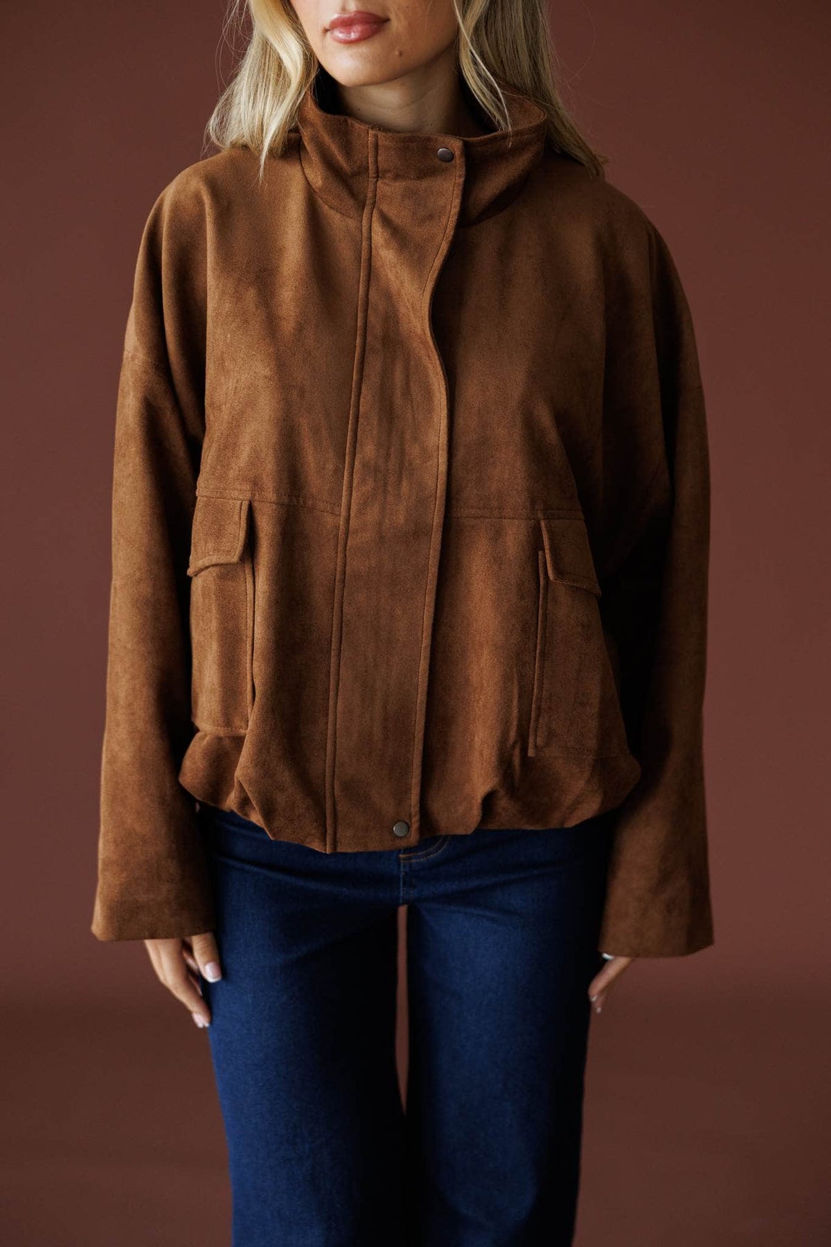 The Outsider Jacket in brown, front close-up of the stand collar and flap pockets