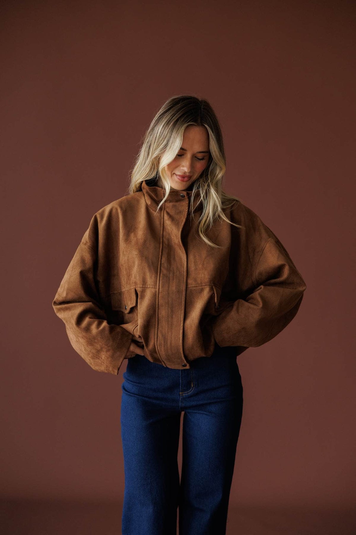 The Outsider Jacket in brown, full-length view with dark wash jeans