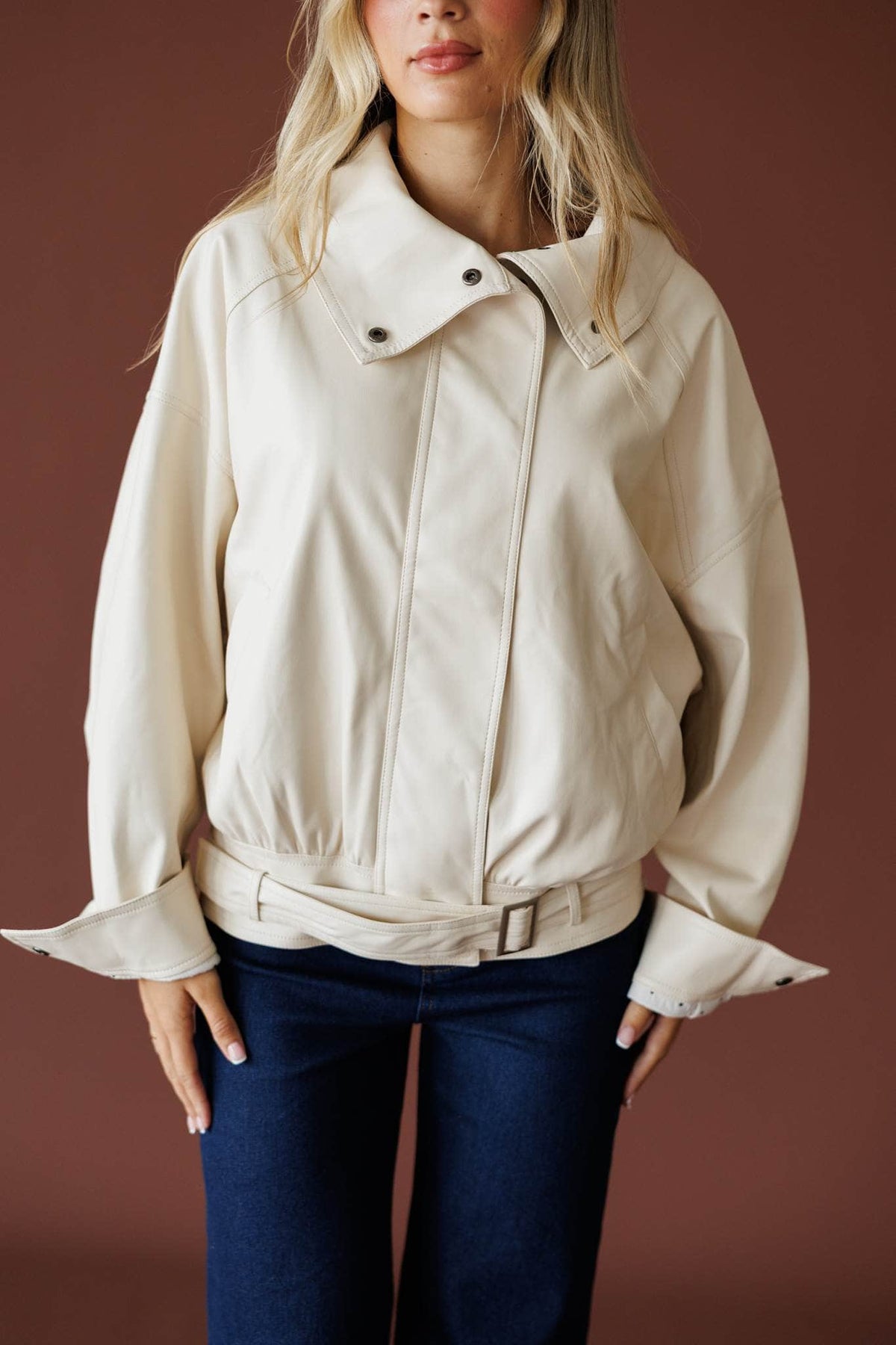 The Waypoint Jacket in cream, front view showing the zip front and buckled hem
