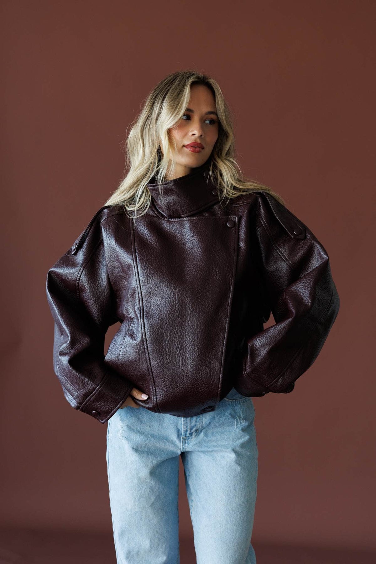 Unlisted Leather Jacket in burgundy, full-length view with light wash jeans