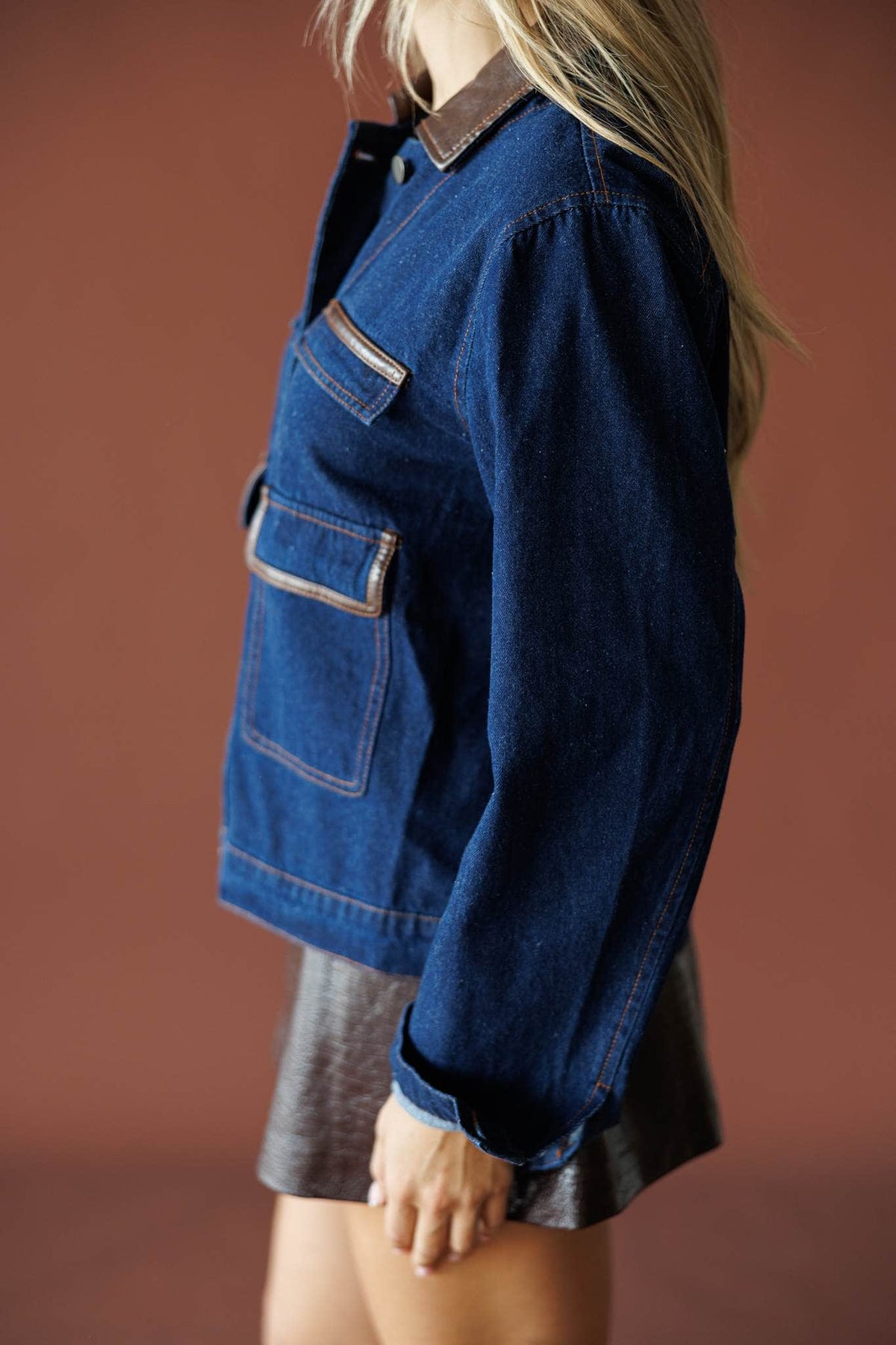 On Location Denim Jacket in medium denim, side view showing the flap pocket and cuff
