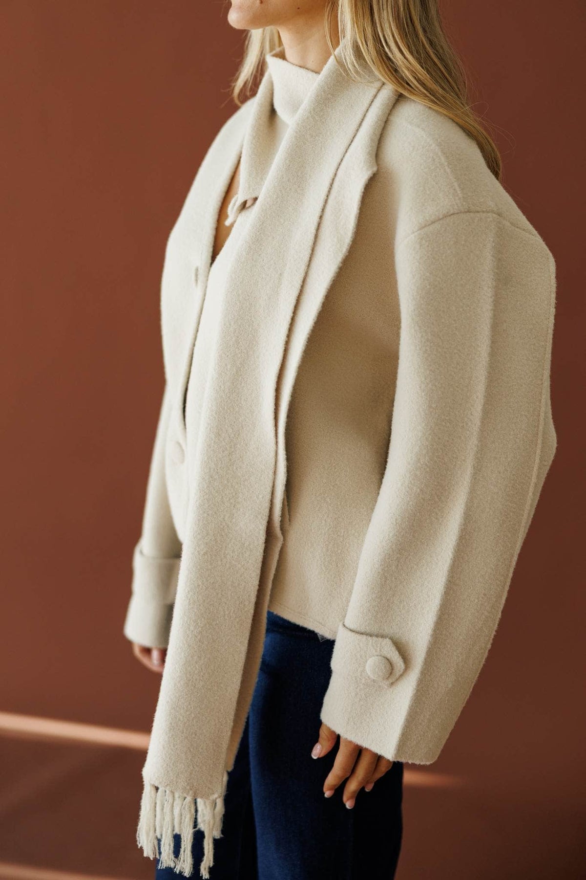 November in New York Sweater in beige, side view showing the attached scarf and sleeve