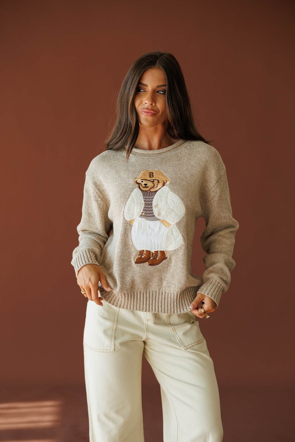 Manhattan Teddy Sweater in taupe, front view on model with hand at the side