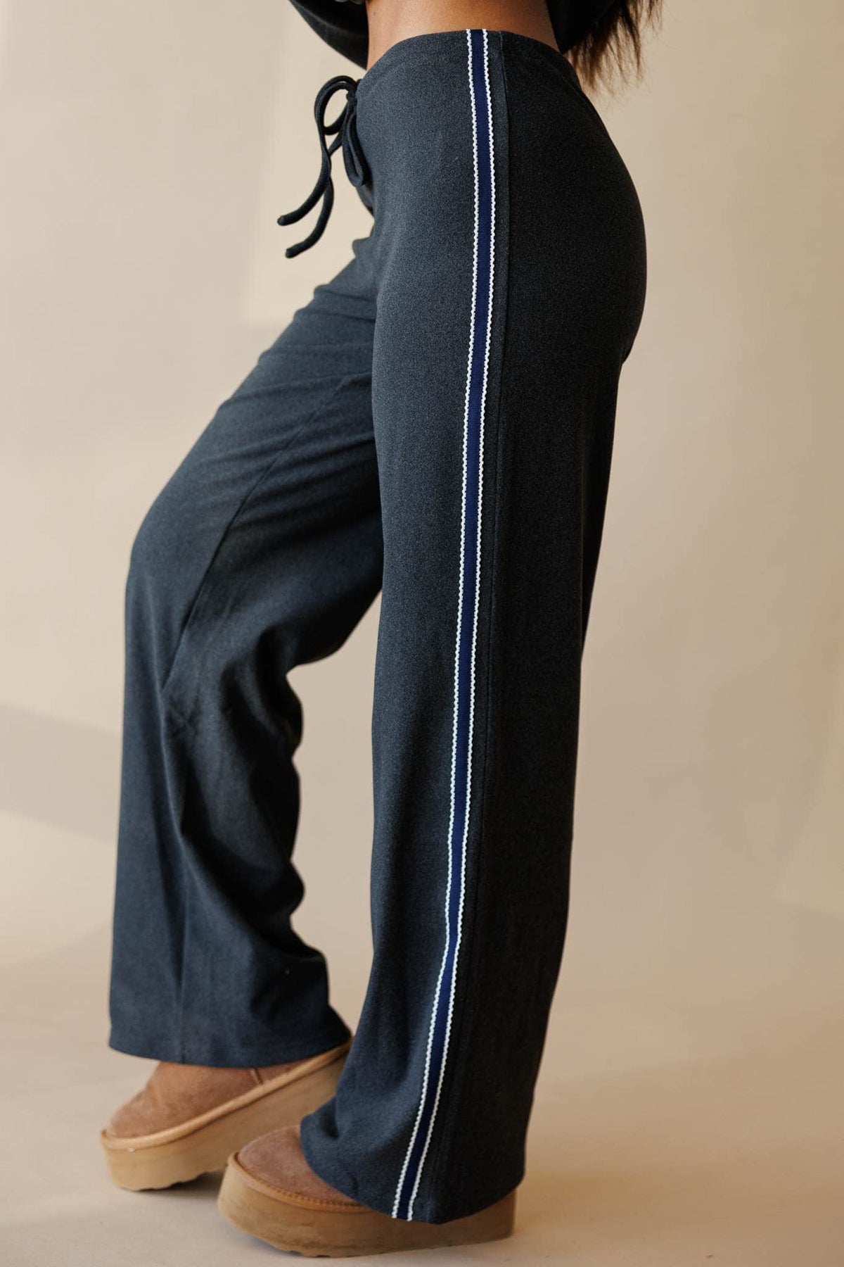 Charcoal track pant with side stripe, front view