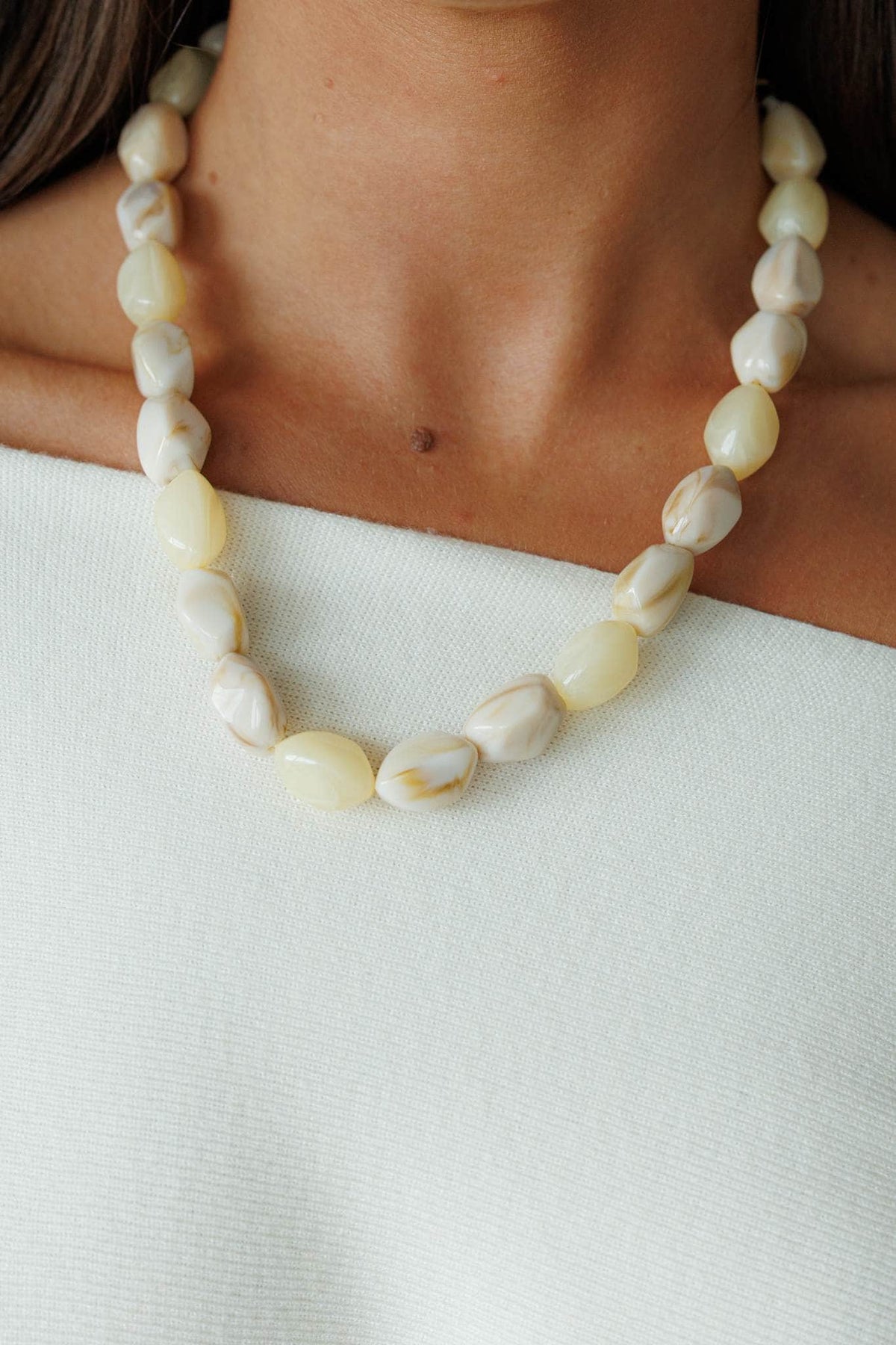 Ivory Shell Nugget Necklace, worn at the neck over a cream top