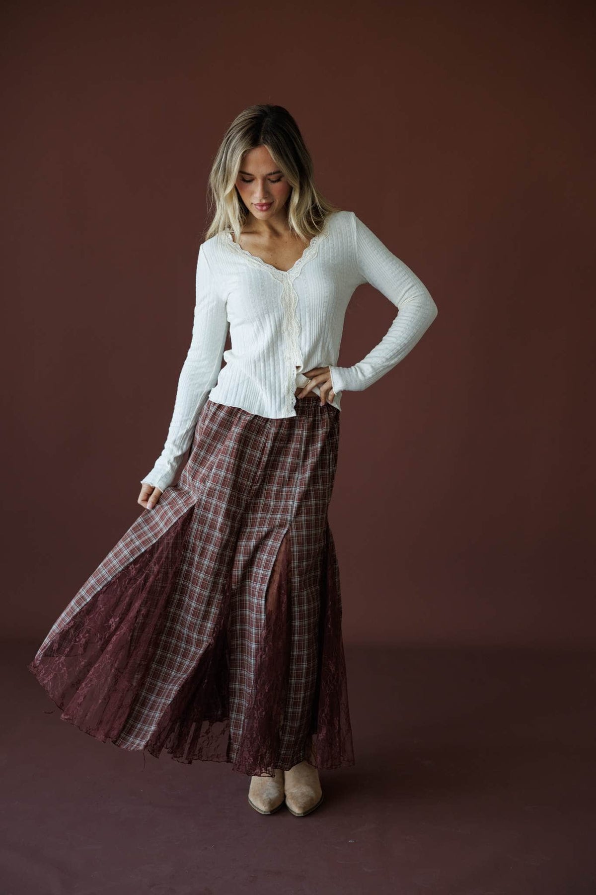 November Novel Plaid Skirt in mulberry, full-length view with a cream knit top
