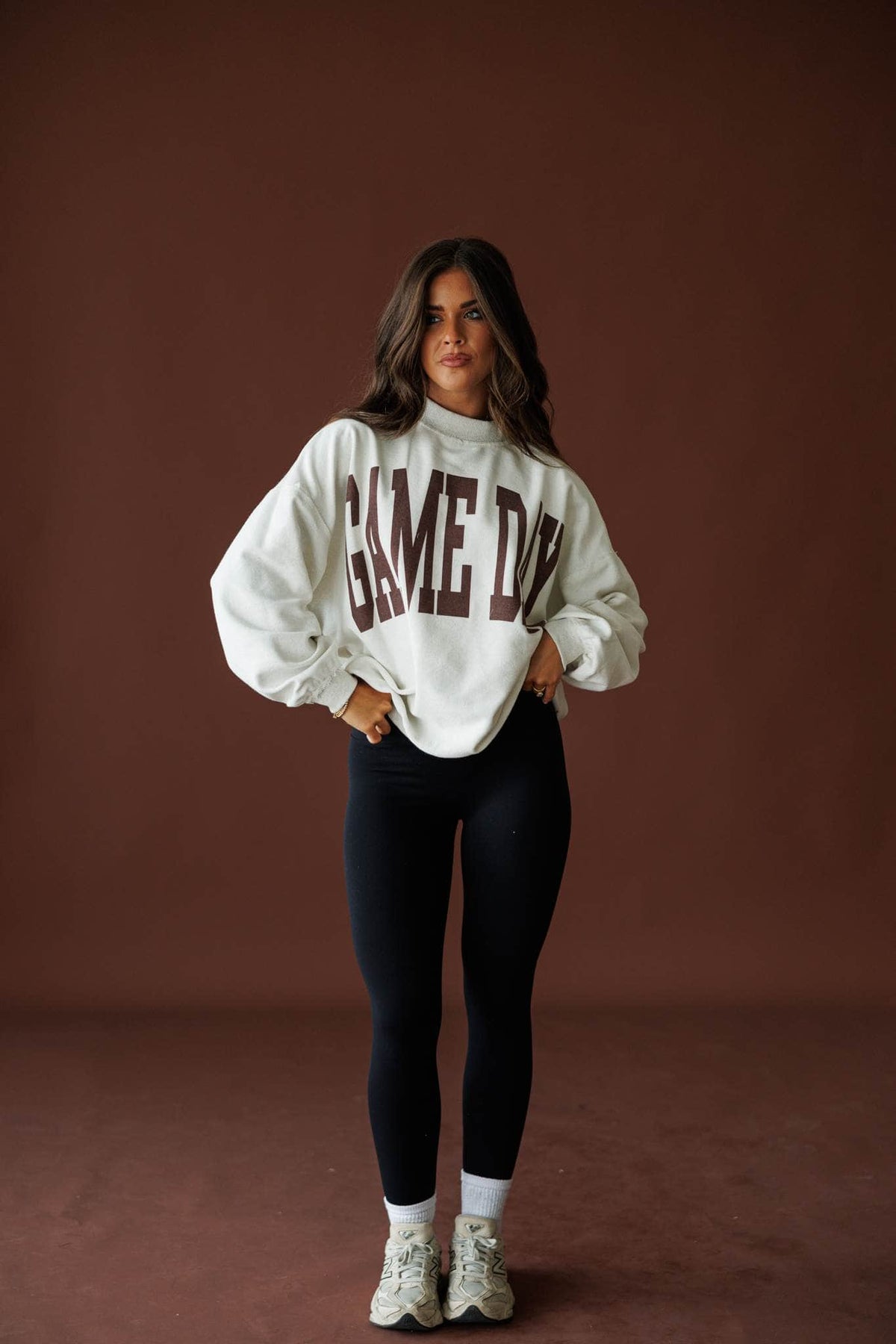 Butter Soft Seamless Leggings in black, full-length view with a Game Day sweatshirt