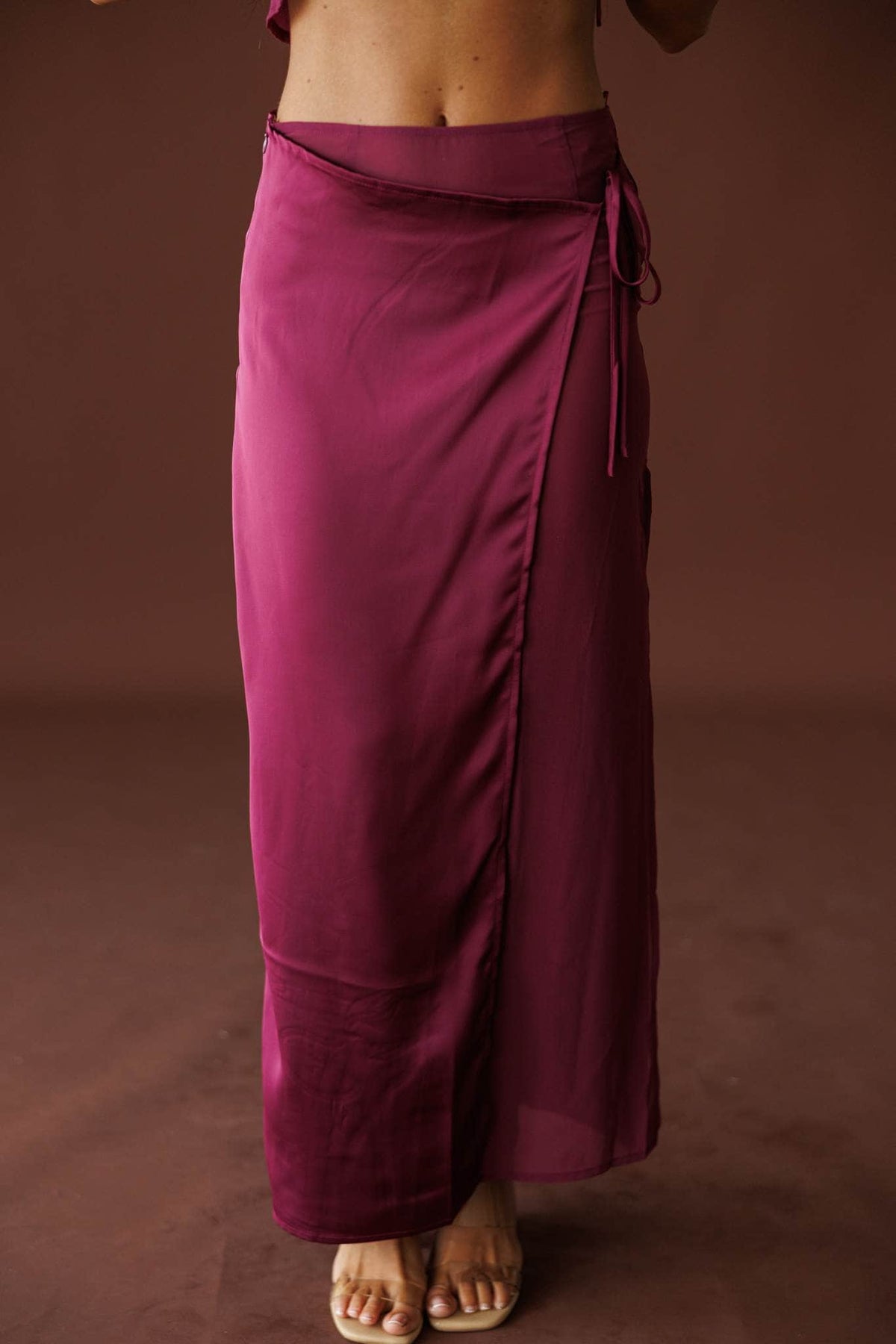 Plum Hour Satin Maxi Skirt in plum, front close-up of the satin wrap and tie waist
