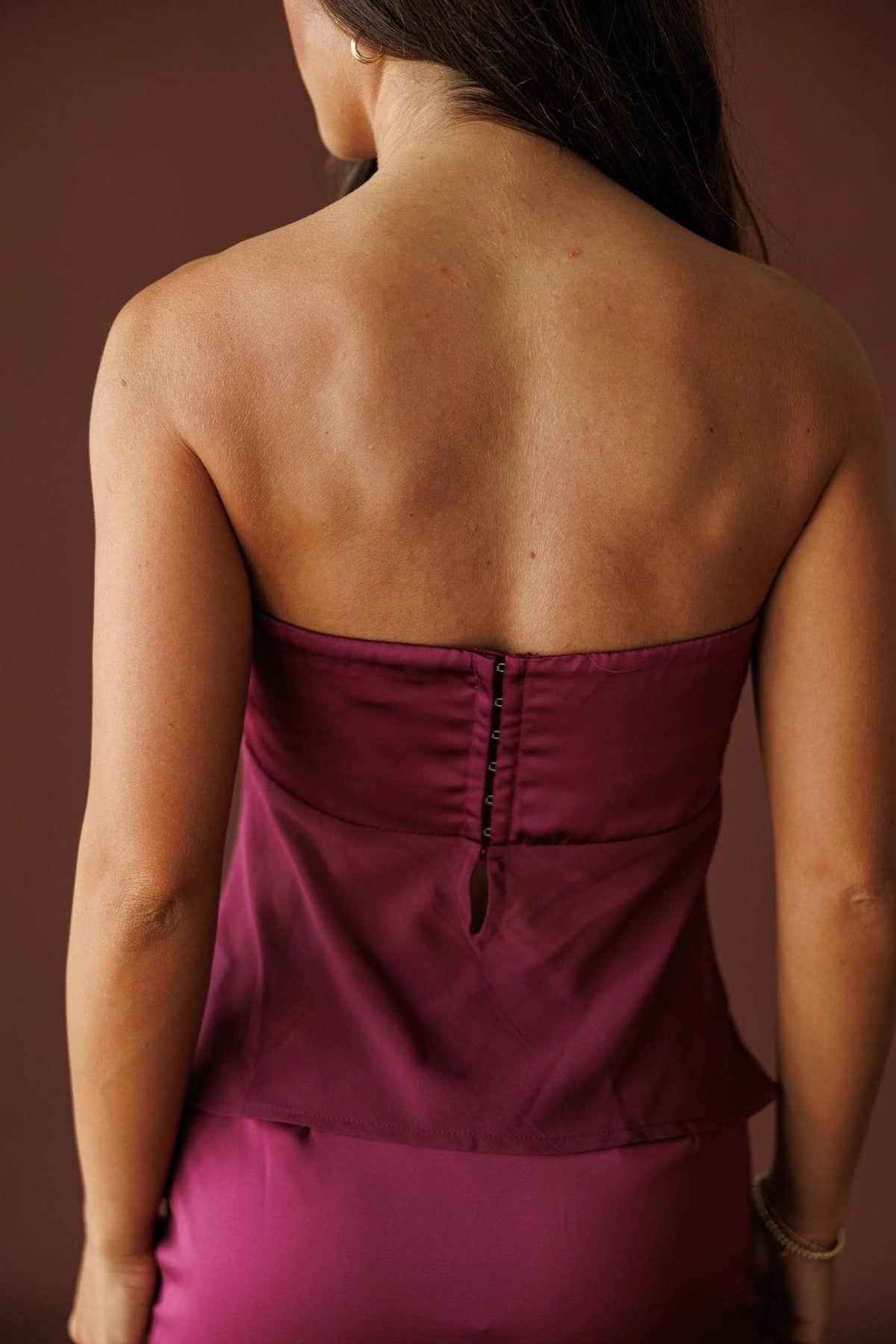 Plum Hour Satin Tube Top in plum, back close-up of the zip back satin top