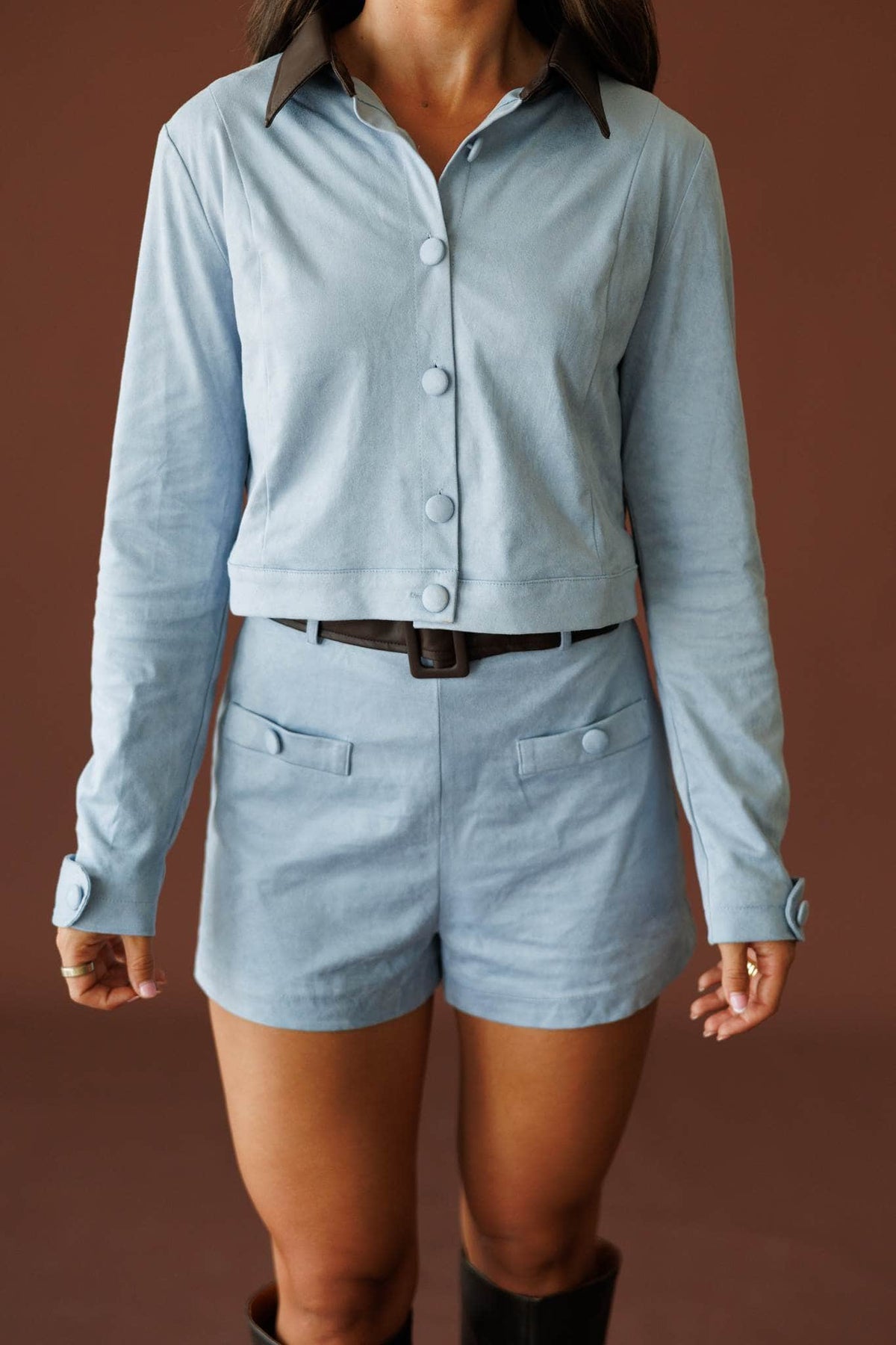 Stable Girl Jacket in dusty blue, front close-up of the button front and cropped hem