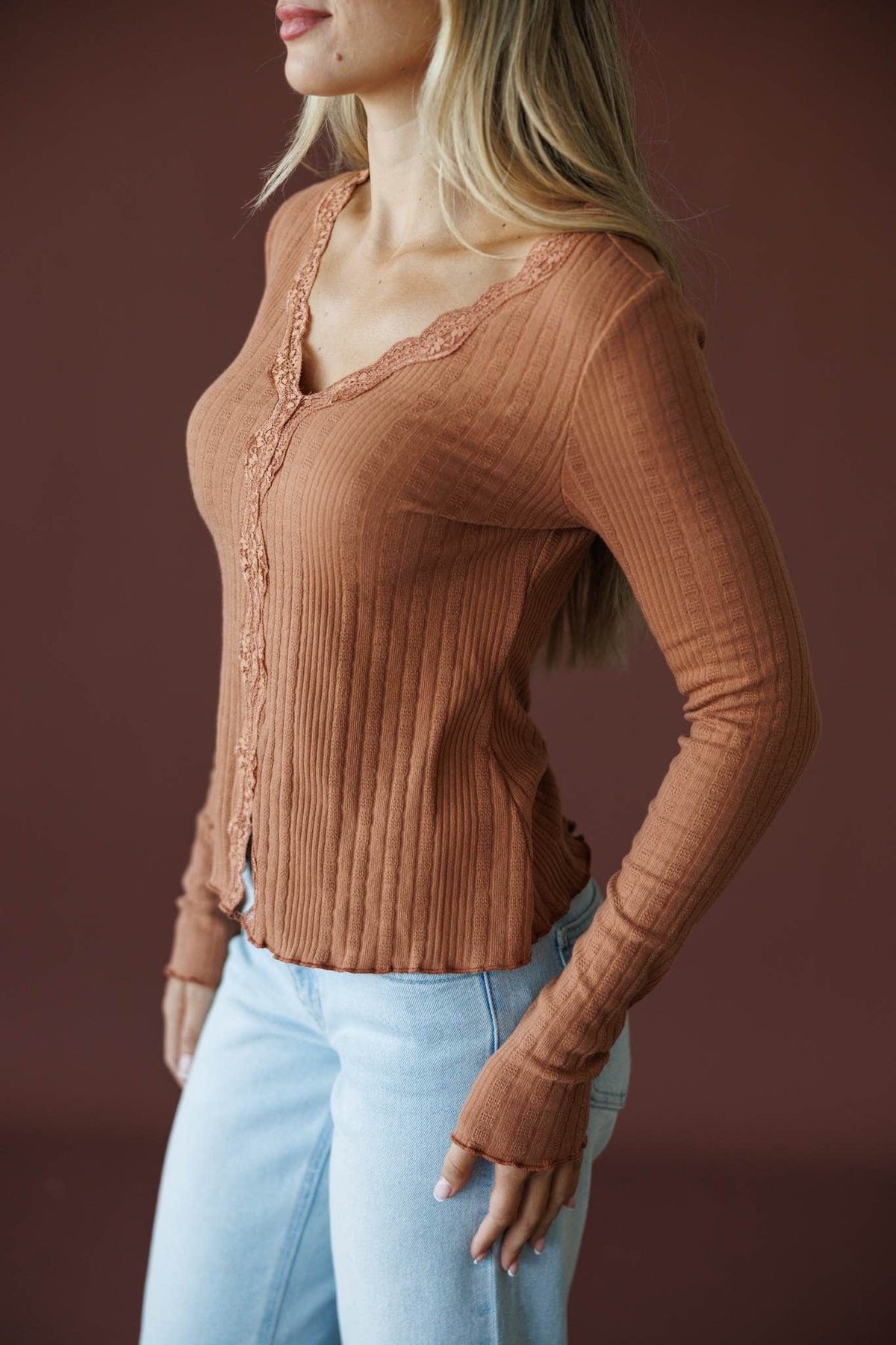 Reminisce Lace Top in sunburn, side view showing the V neck and ribbed knit