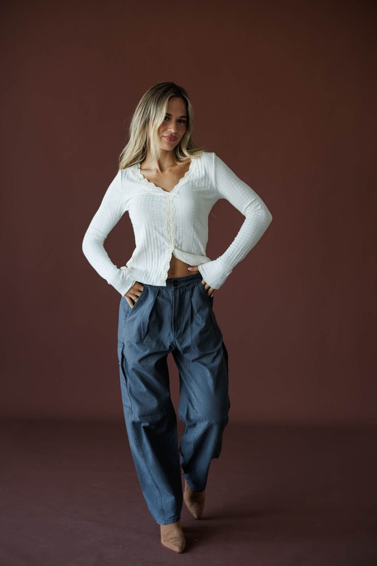 Reminisce Lace Top in cream, full-length view on model with hand on hip