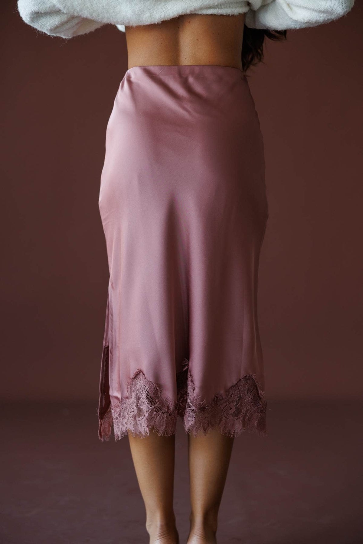 Satin Secrets Lace Midi Skirt in rose dawn, back view showing the bias satin and lace hem