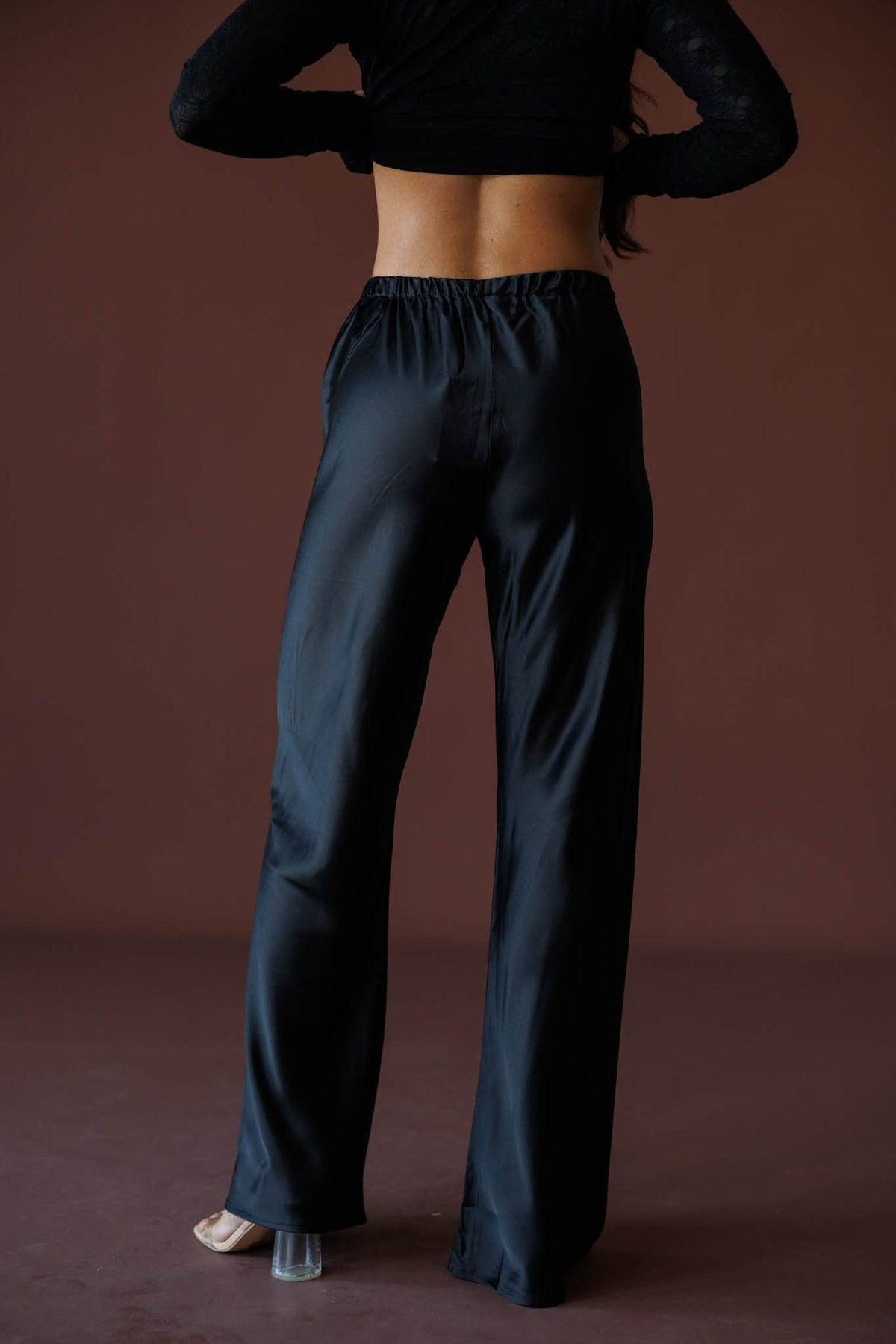 Satin State Pants in black, back view showing the elastic waist and wide leg